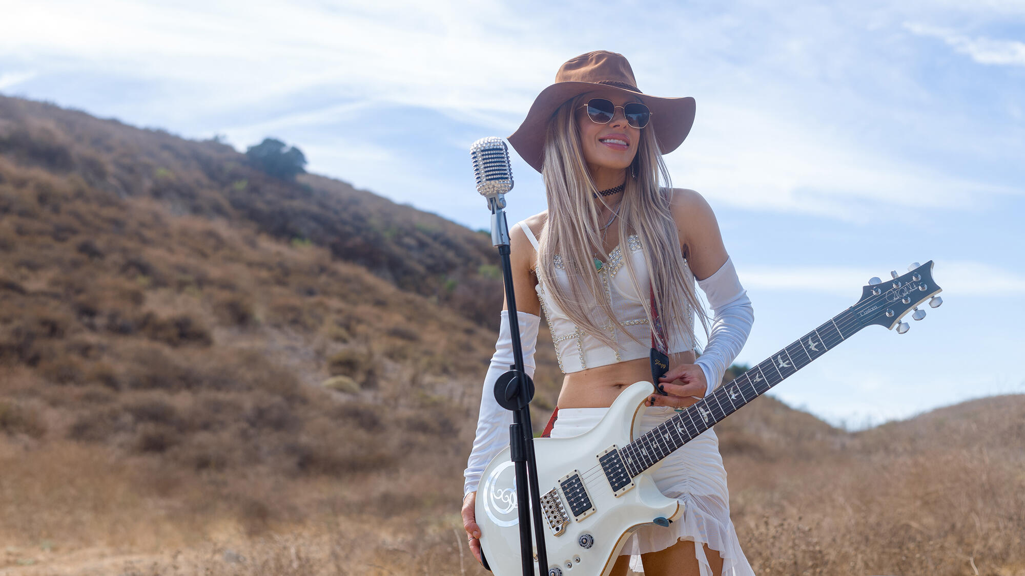 Orianthi performing with her electric guitar. 