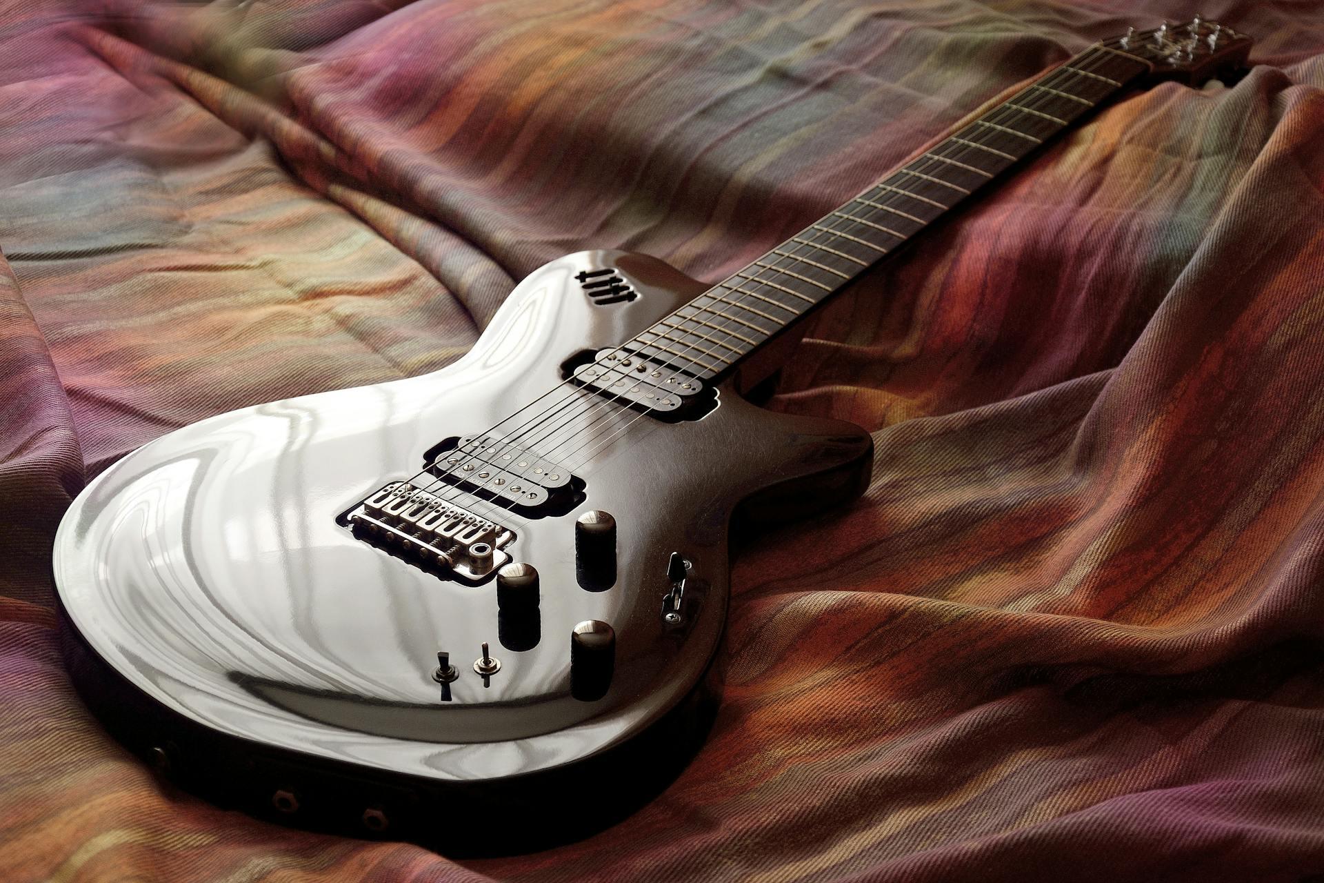 Electric guitar placed on a coloured cloth piece for display.