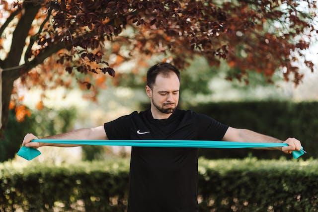 A man stretching a long resistance band