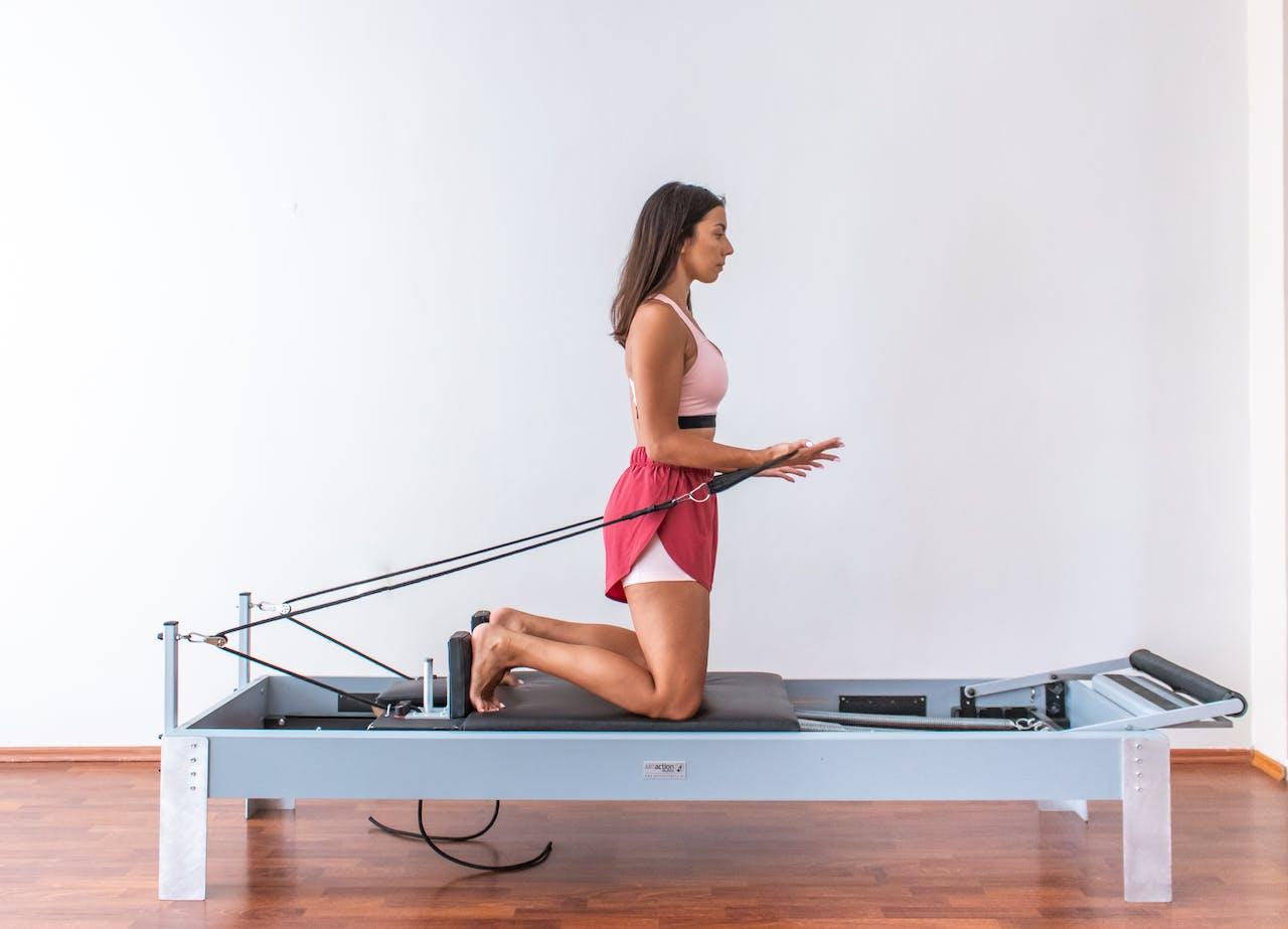Woman using Pilates Reformer