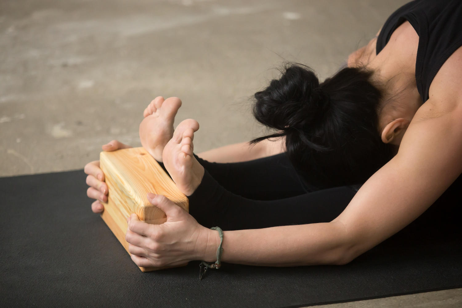 A yogi using a block in their yoga practise
