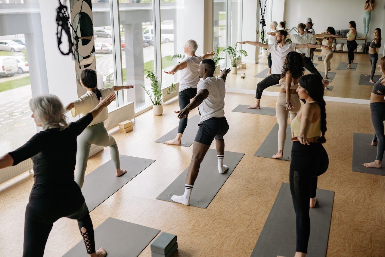 A class of yoga students following the instructor