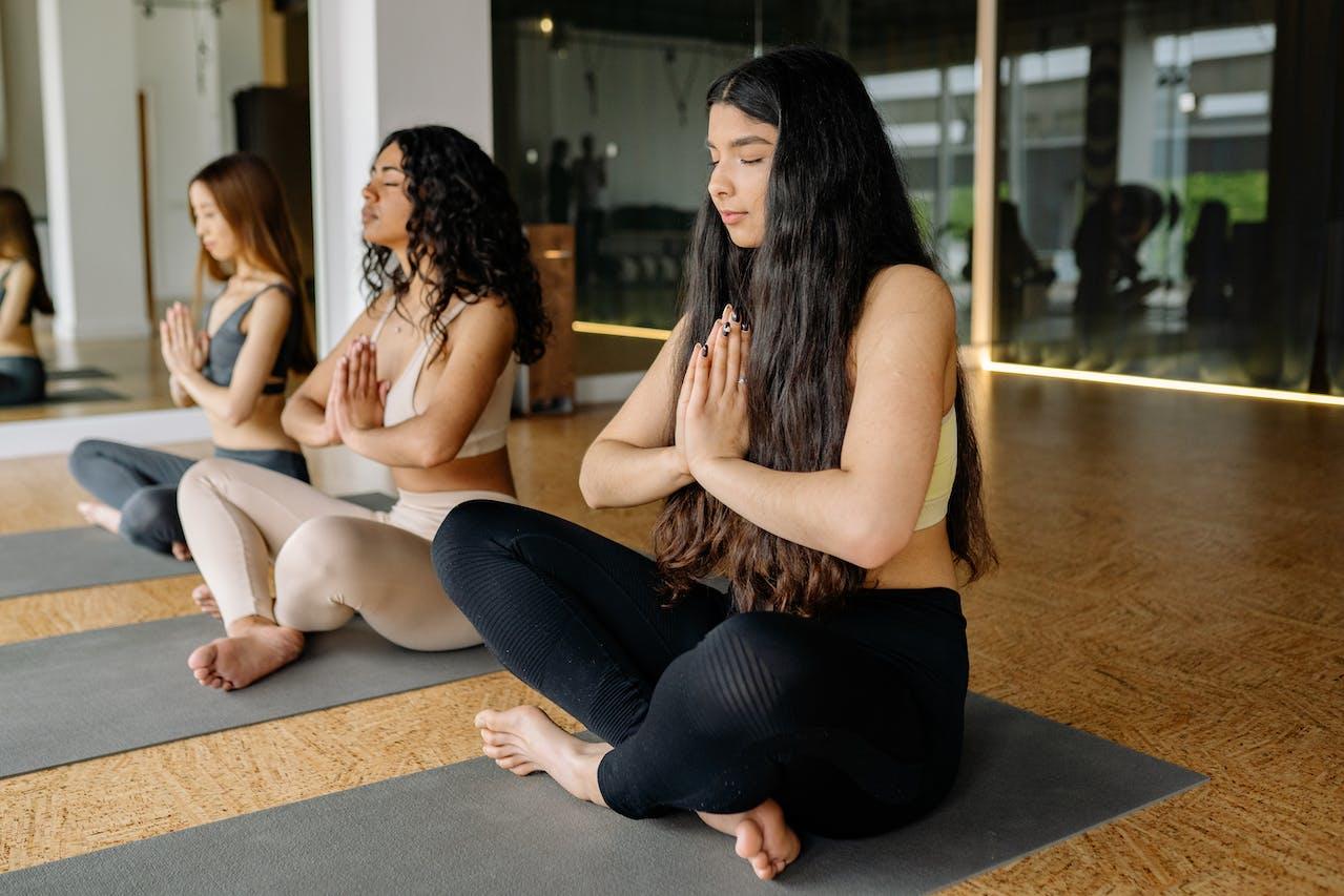 Students in a yoga class practising meditation