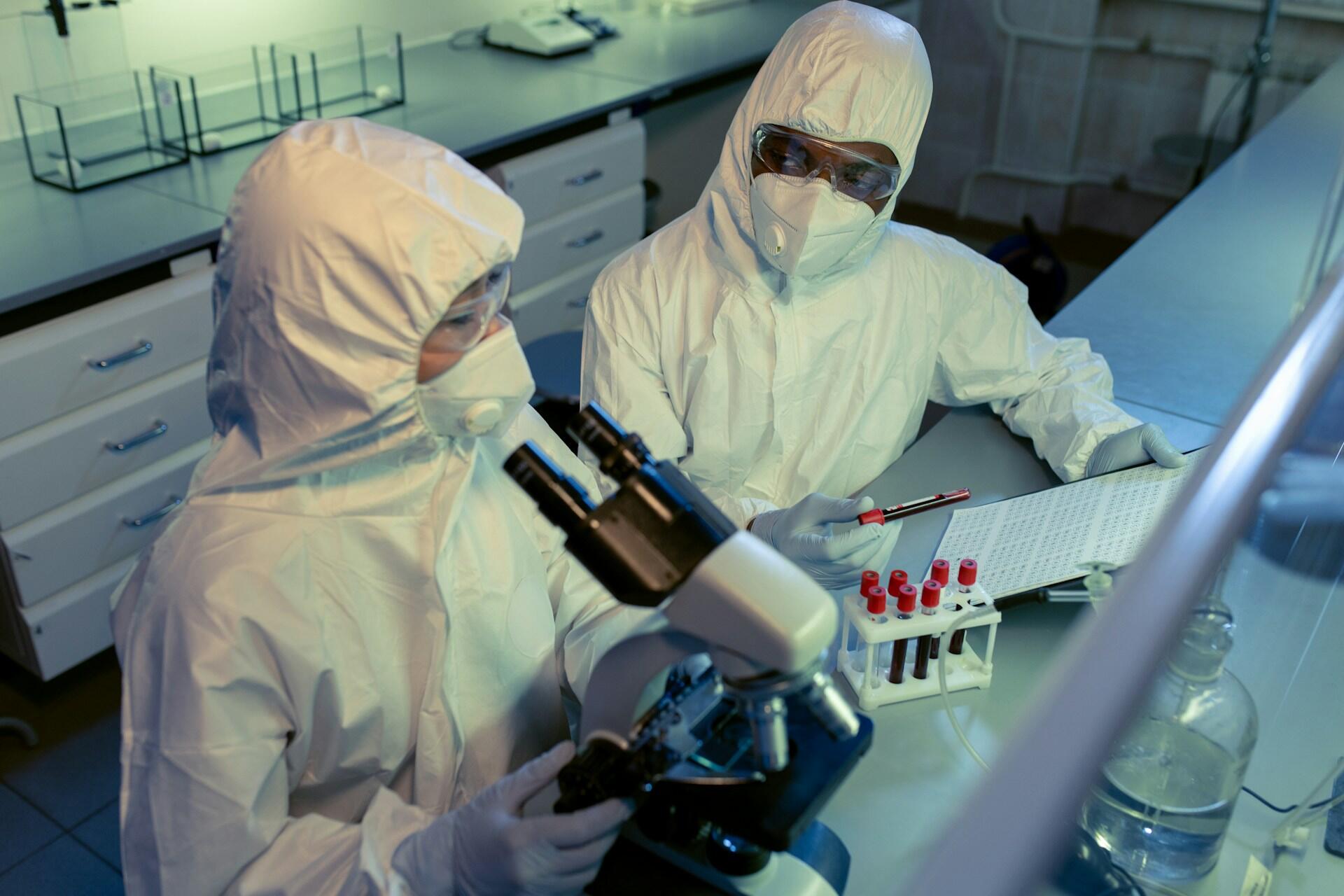 Two people in safety gear in a laboratory.