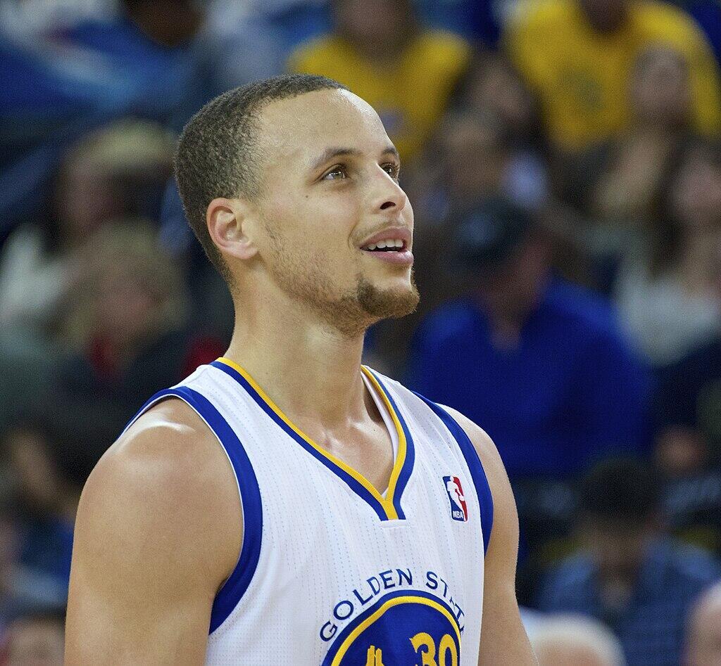Stephen Curry looking up on the basketball court.