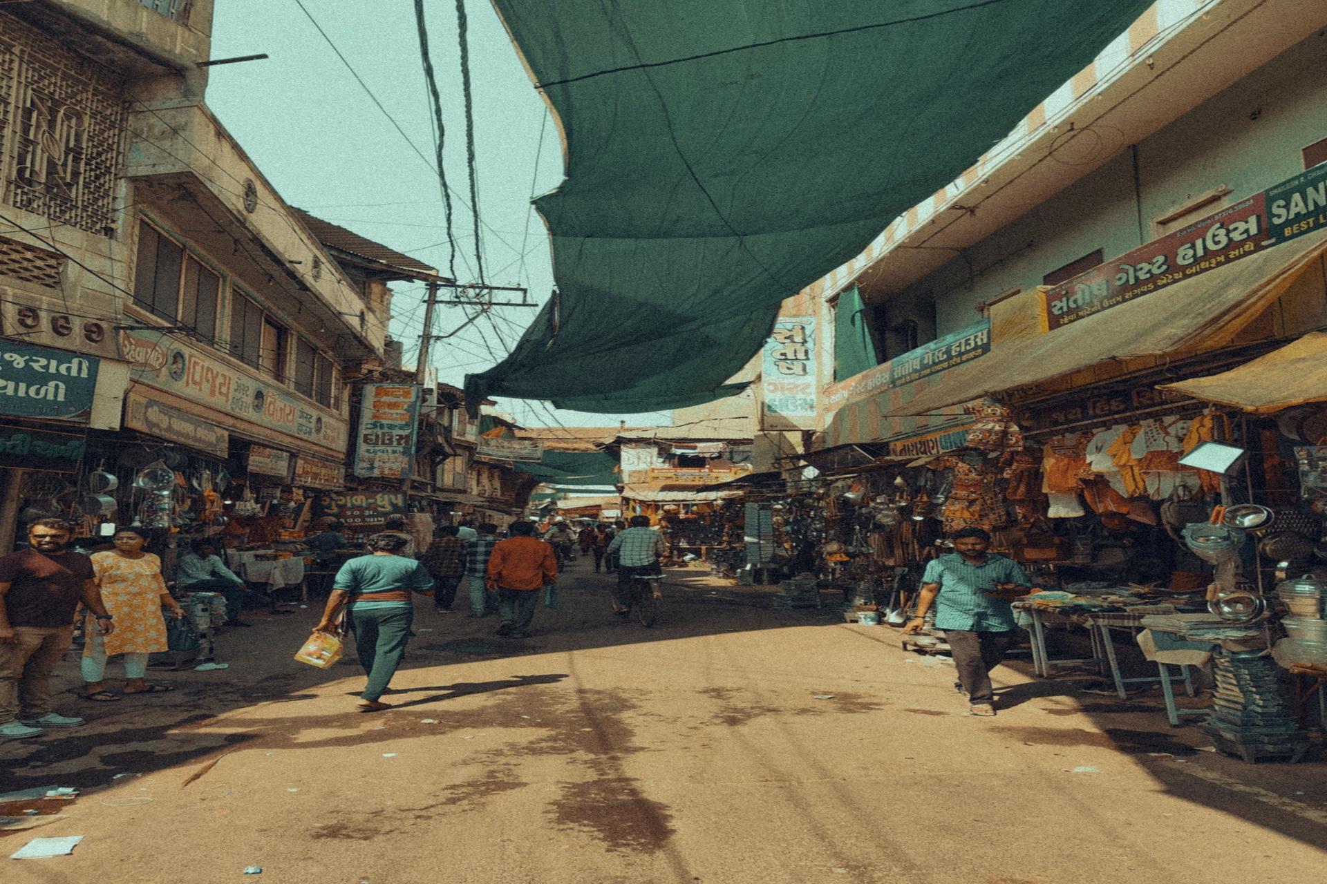 Busy Indian street market with vendors and shoppers, illustrating real-life Hindi conversation and sentence structure usage.