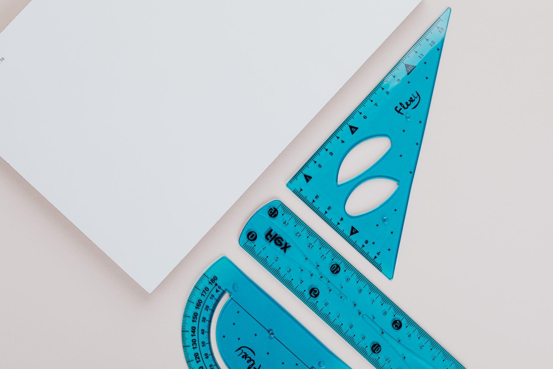 Close-up image of blue geometry tools on white background for educational use.