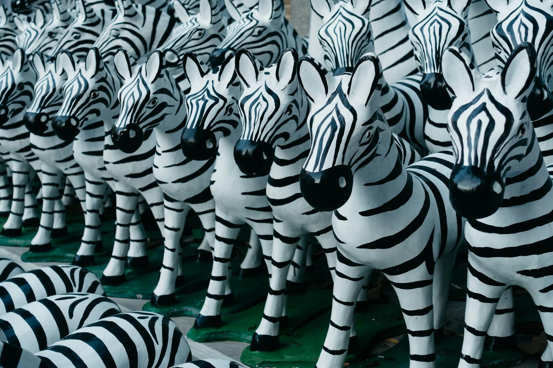 A series of zebra figurines.