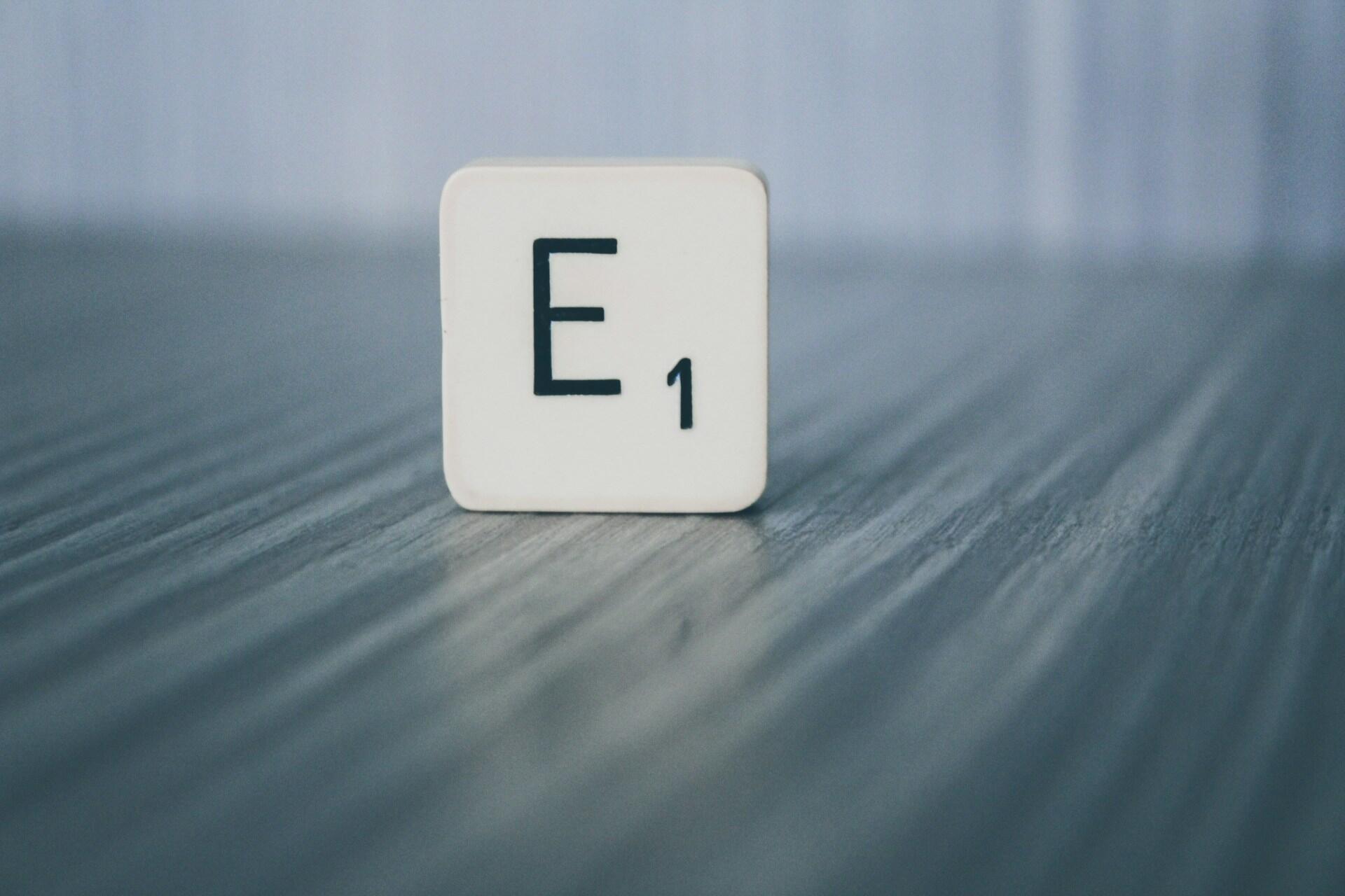 A scrabble tile with the letter E.