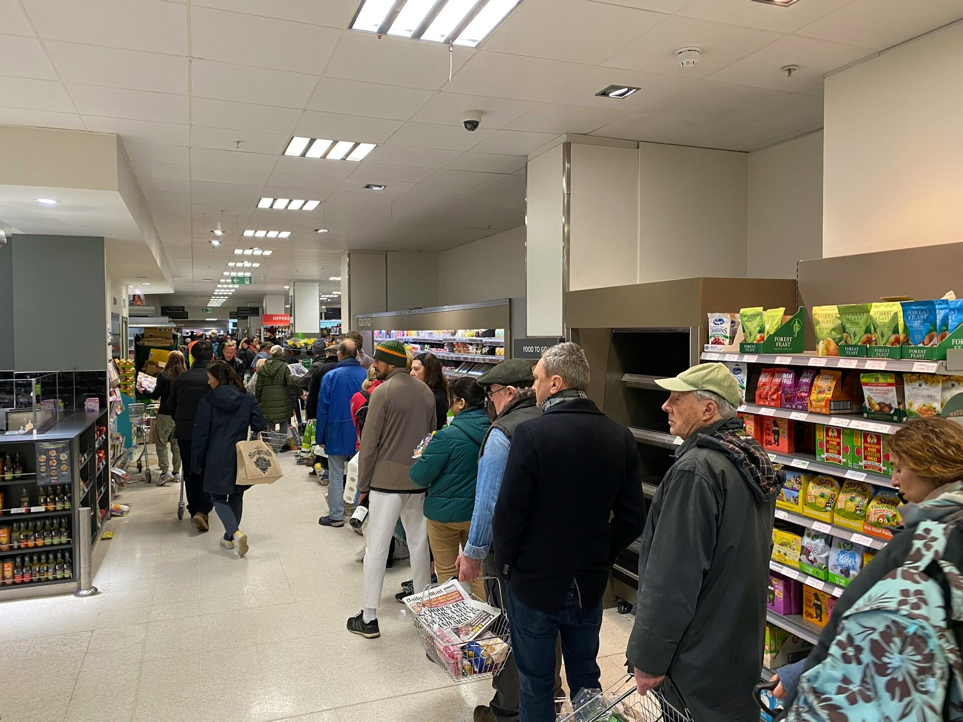 People queueing in a supermarket.