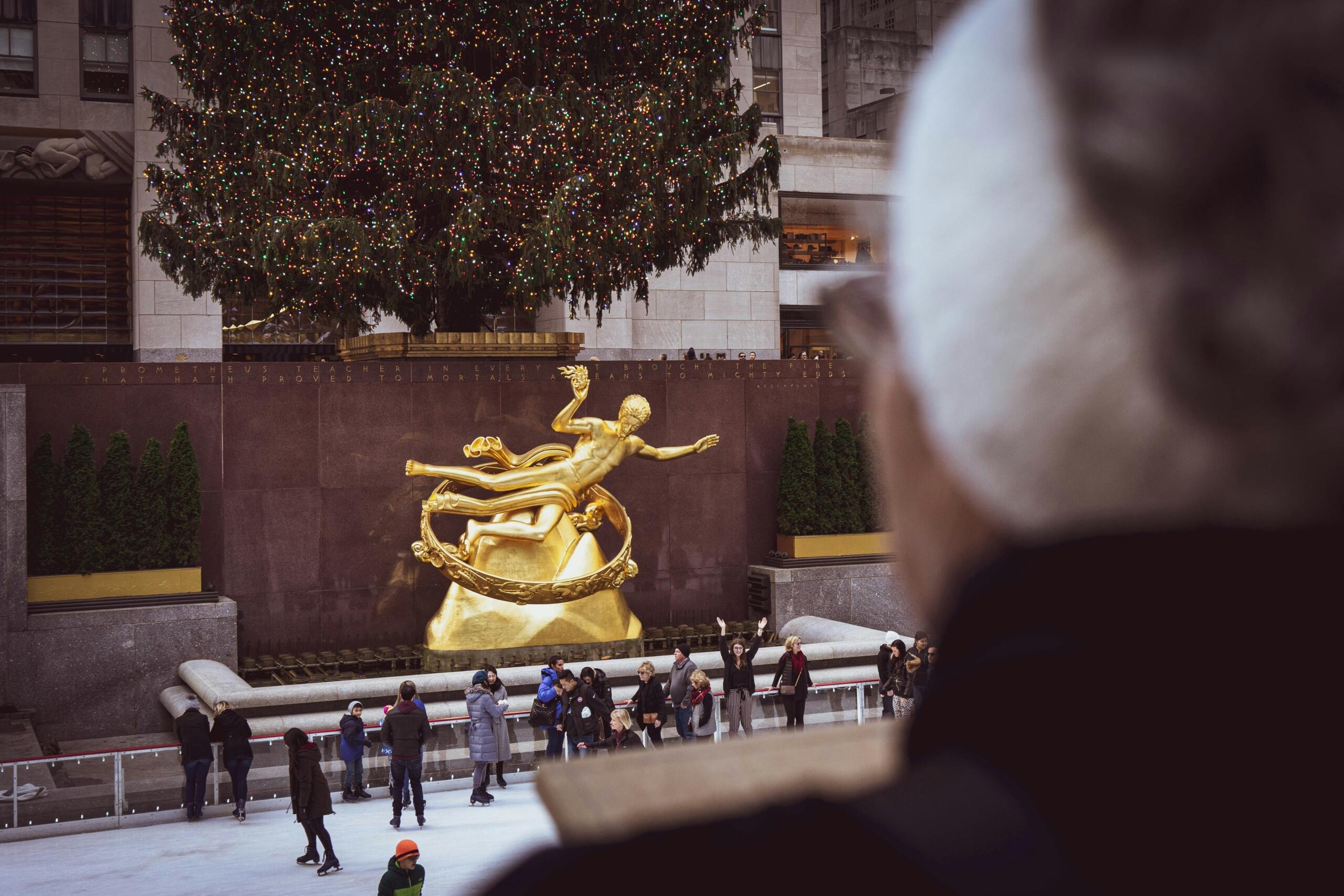 A person watching skaters at Rockefeller Center, New York. 