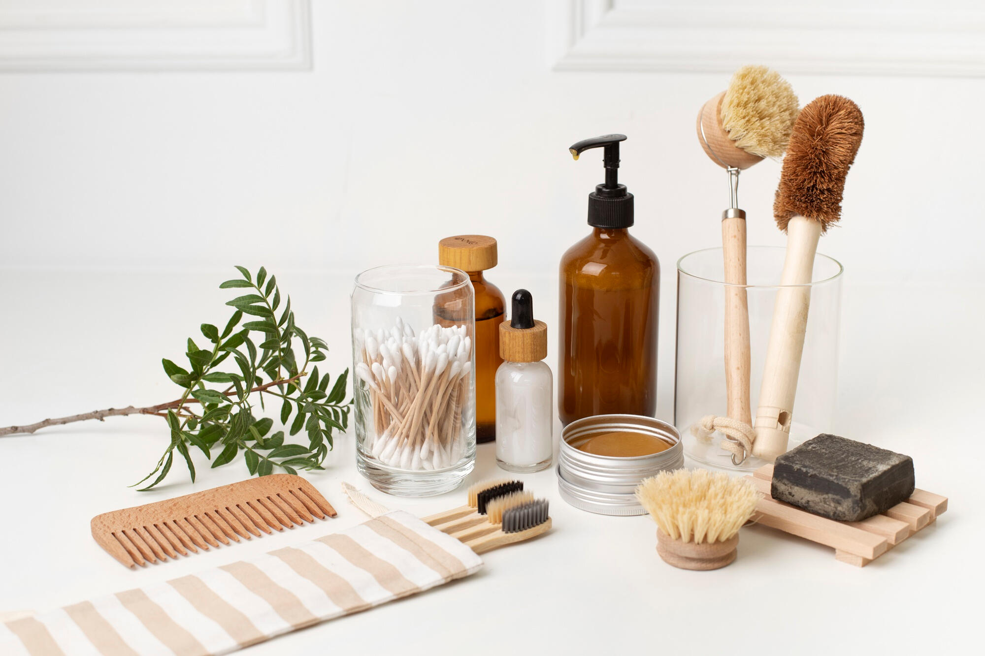 A collection of wooden products, including a brush, soap, and a towel, arranged neatly on a surface.