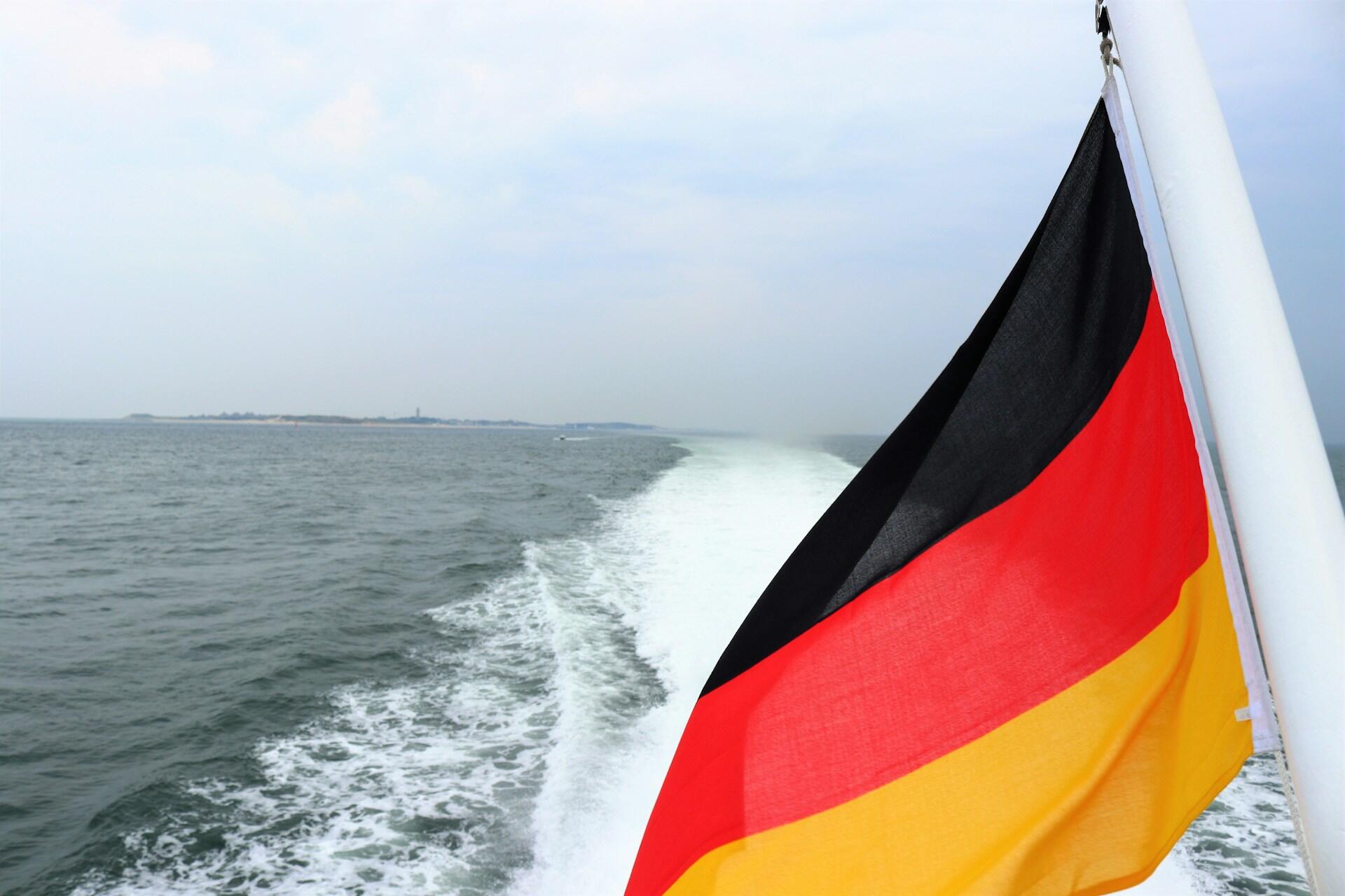 German flag on a boat with water behind it