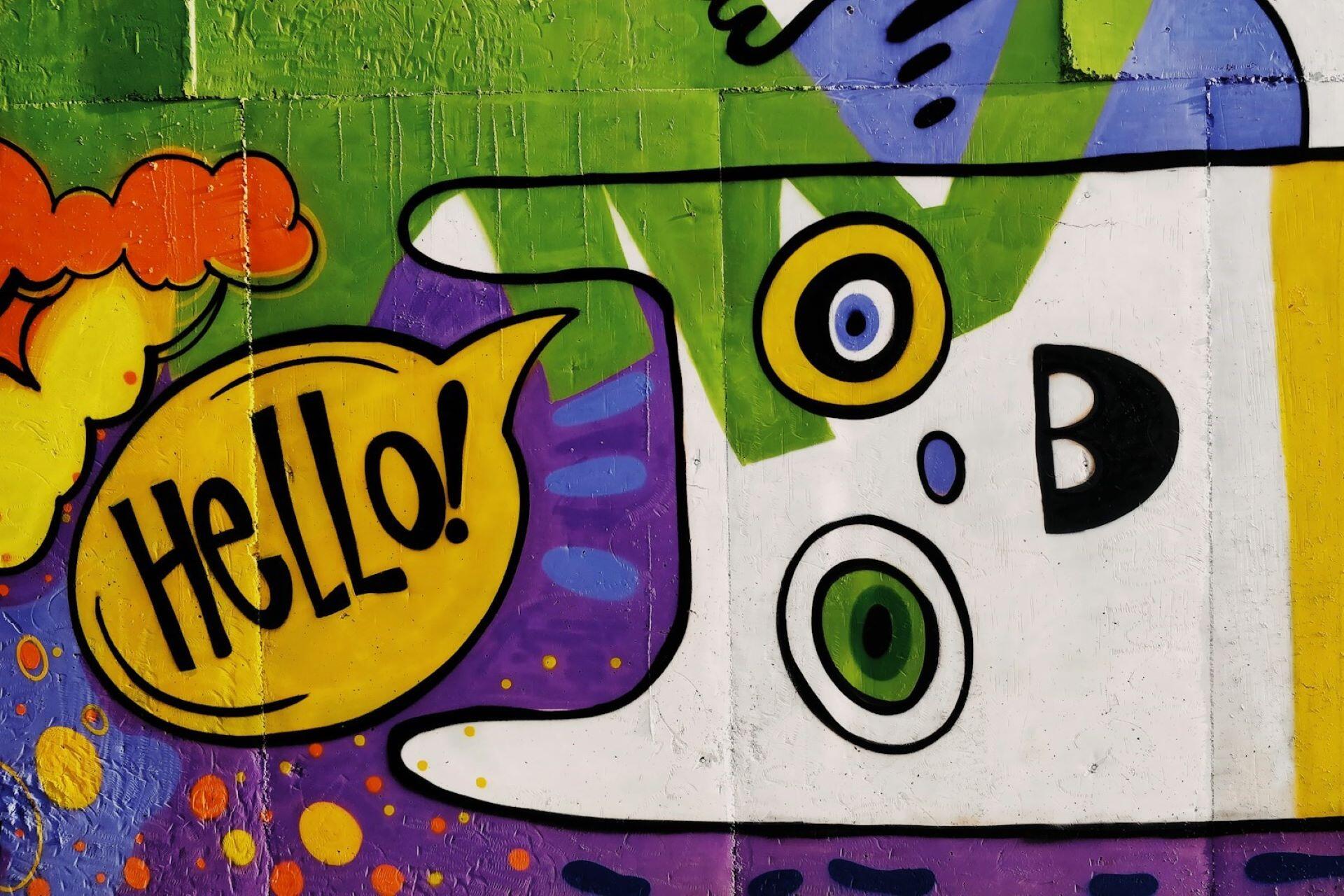 Colourful wall mural with the word hello in a speech bubble