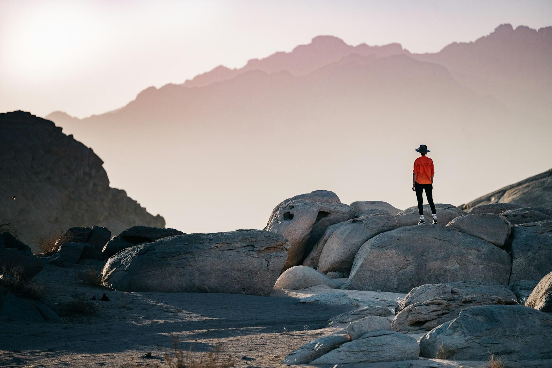 Person standing on rocks in a mountain landscape
