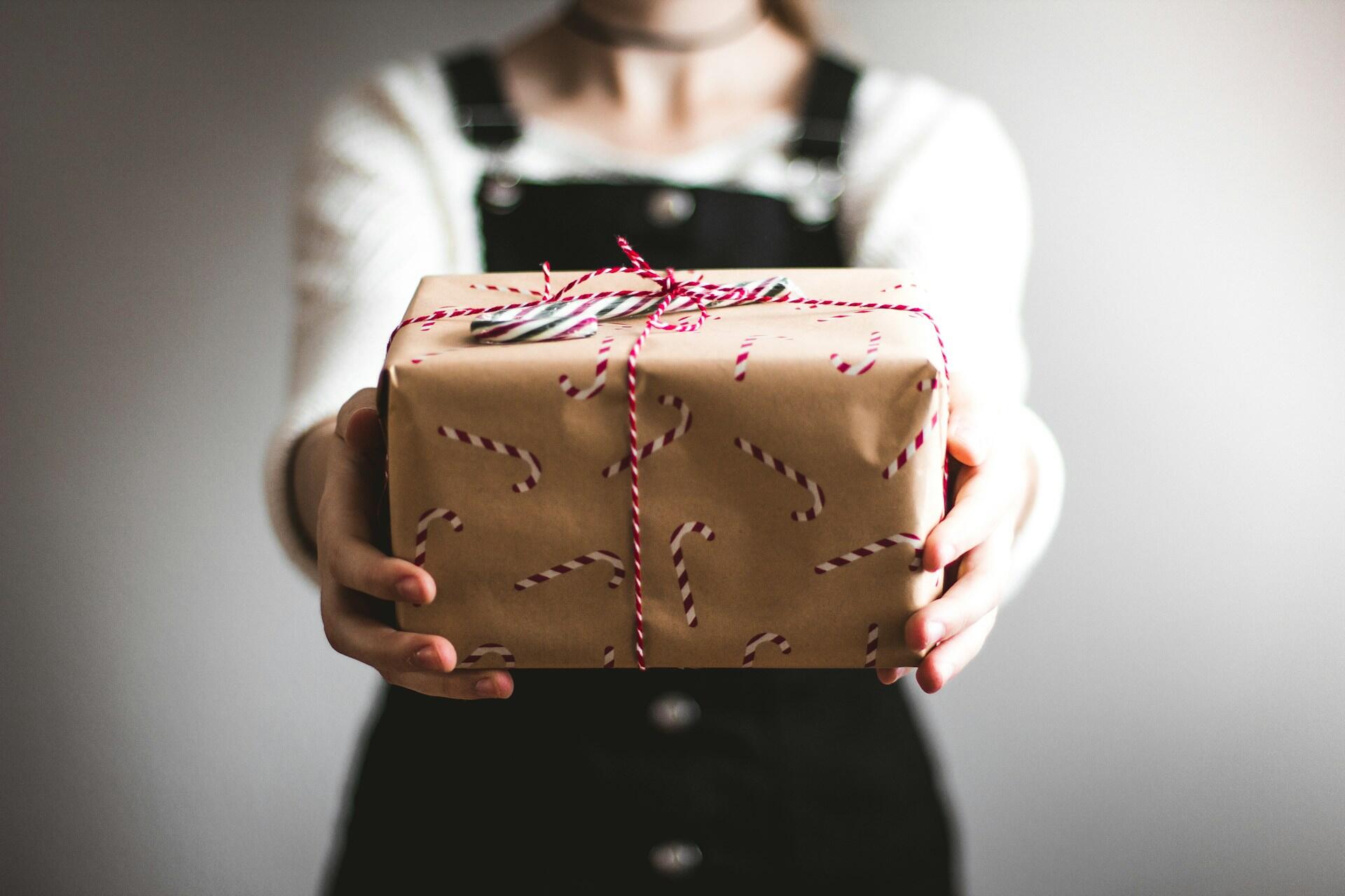 Person holding a wrapped present with string