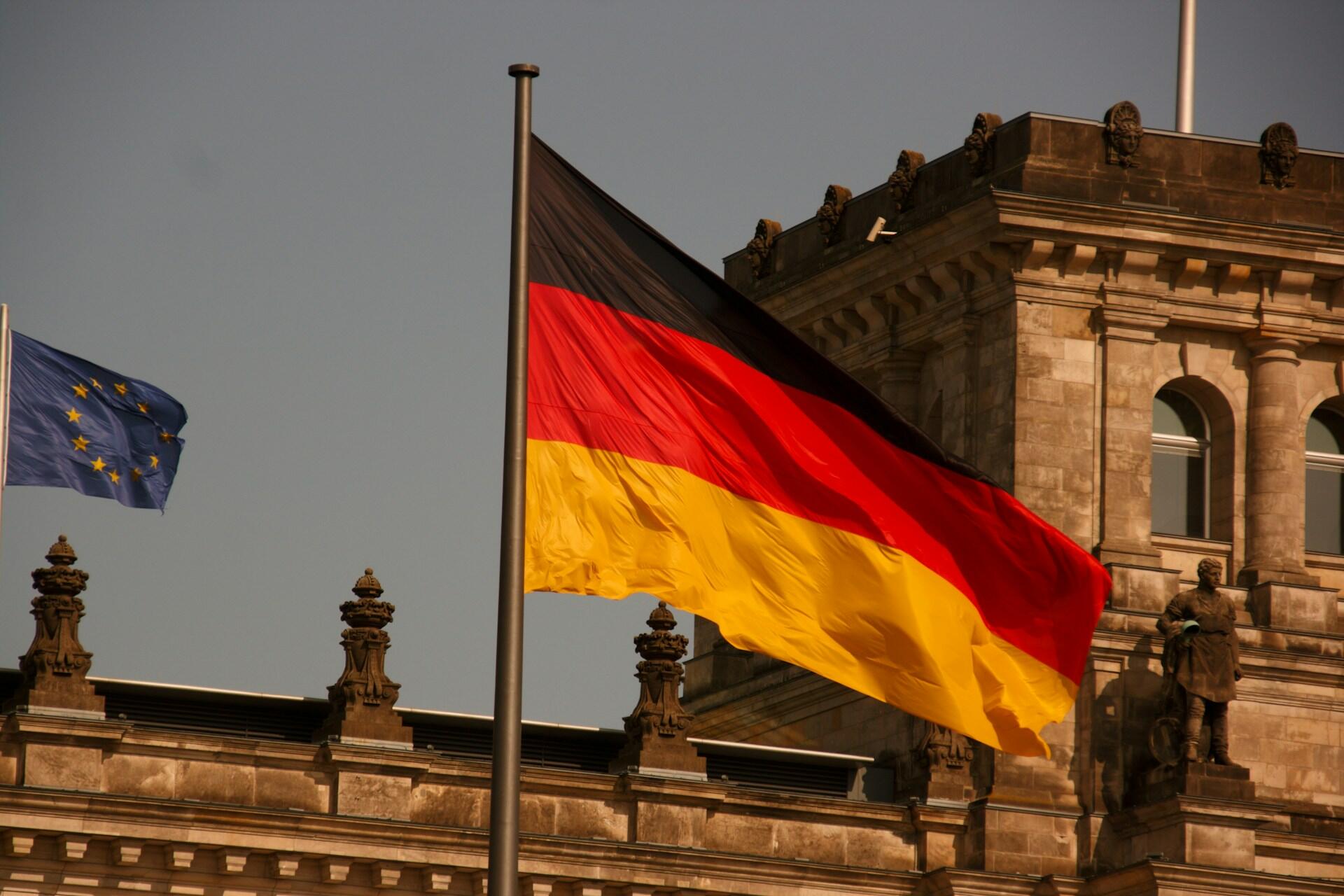 German flag flying in front of a stone building