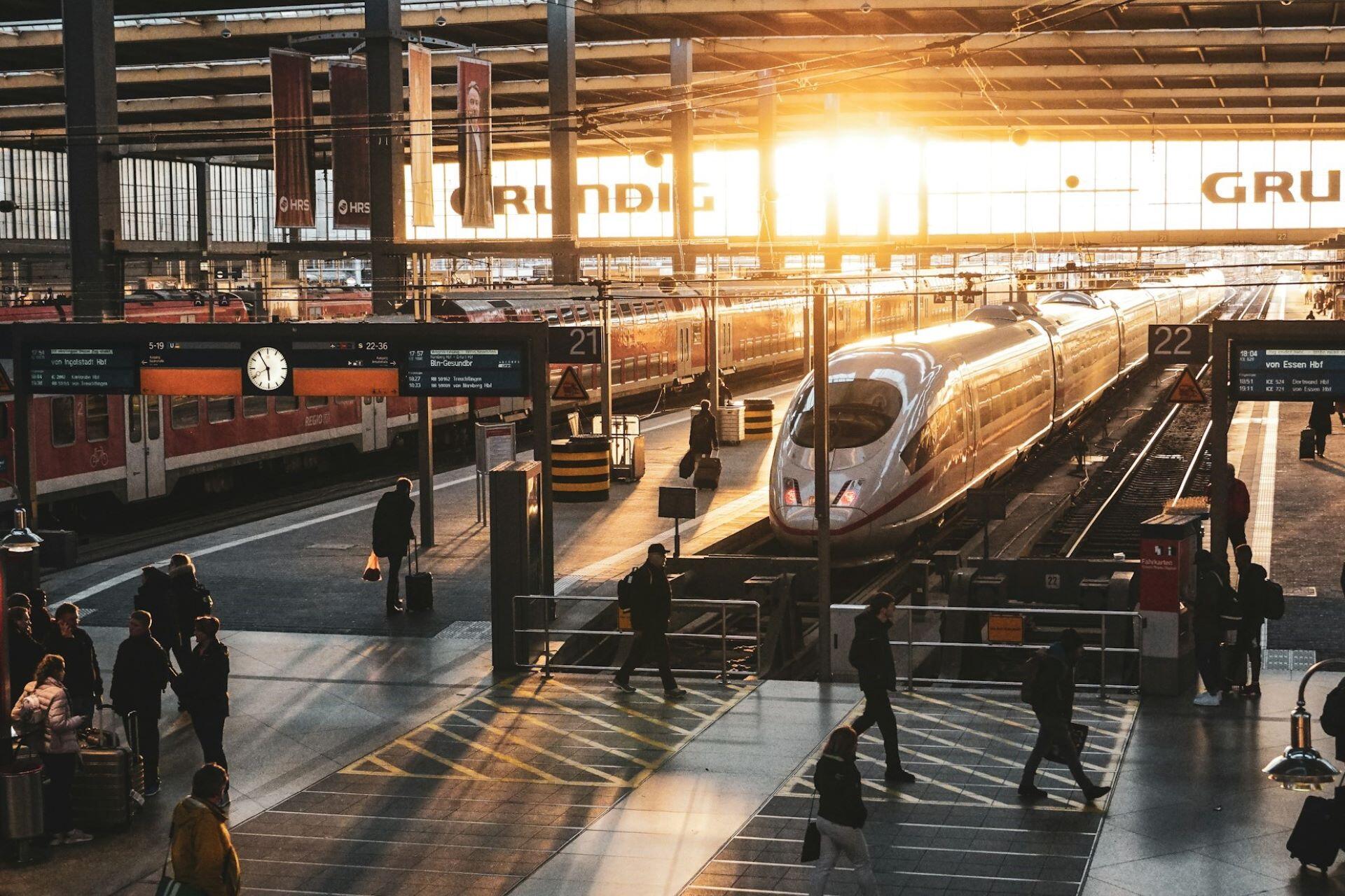 Train at a railway station with passengers on the platform