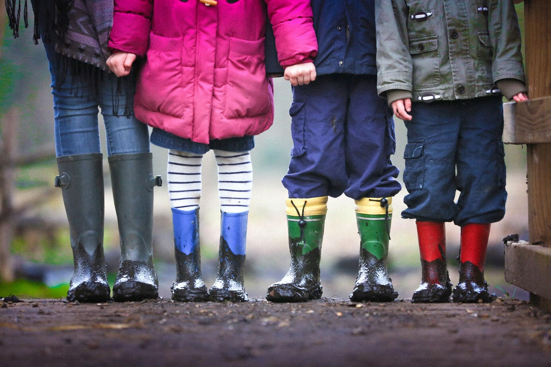 Children standing in muddy boots