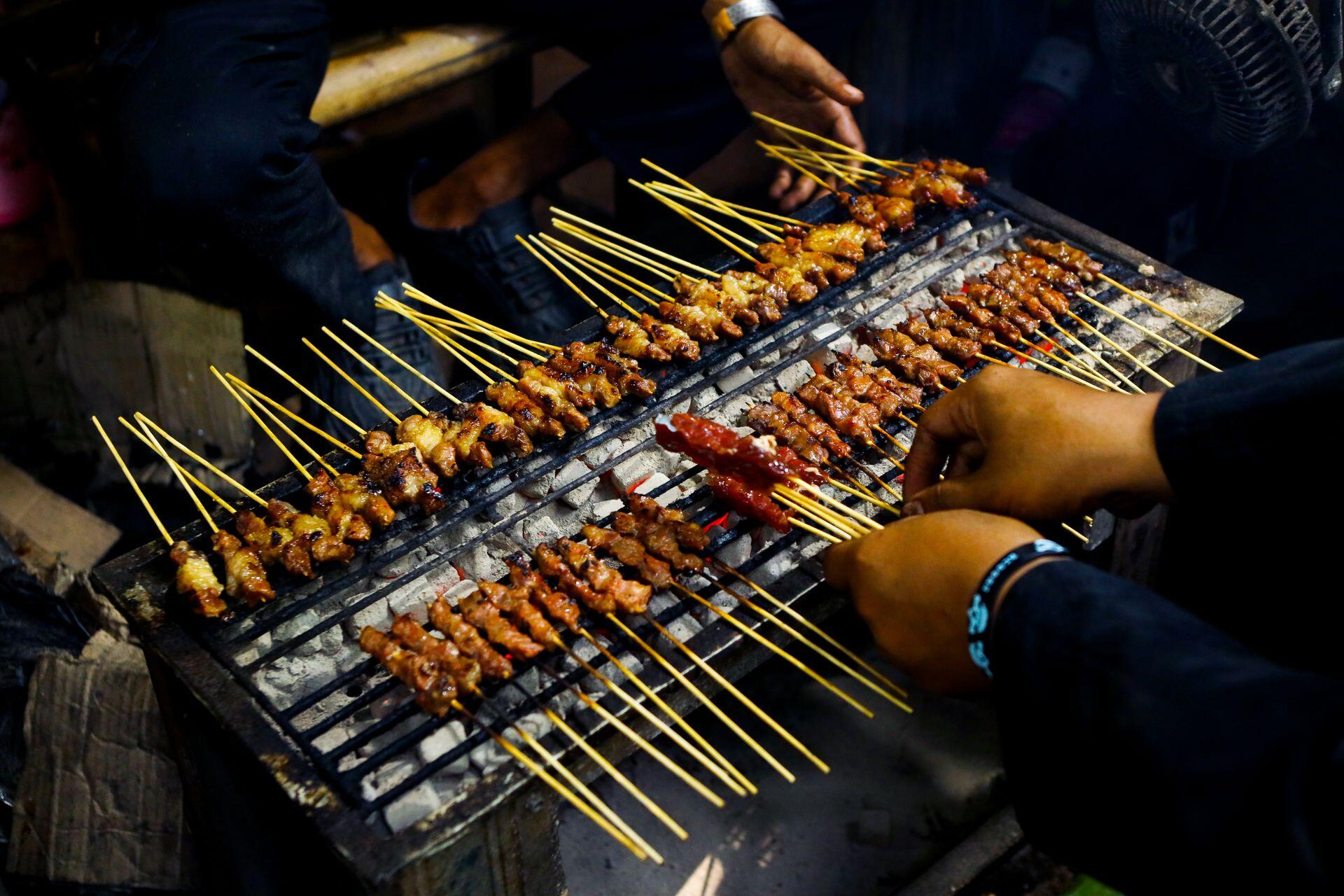 Authentic satay grilling scene from Jawa Barat, Indonesia showcasing traditional cooking methods and cultural culinary art.