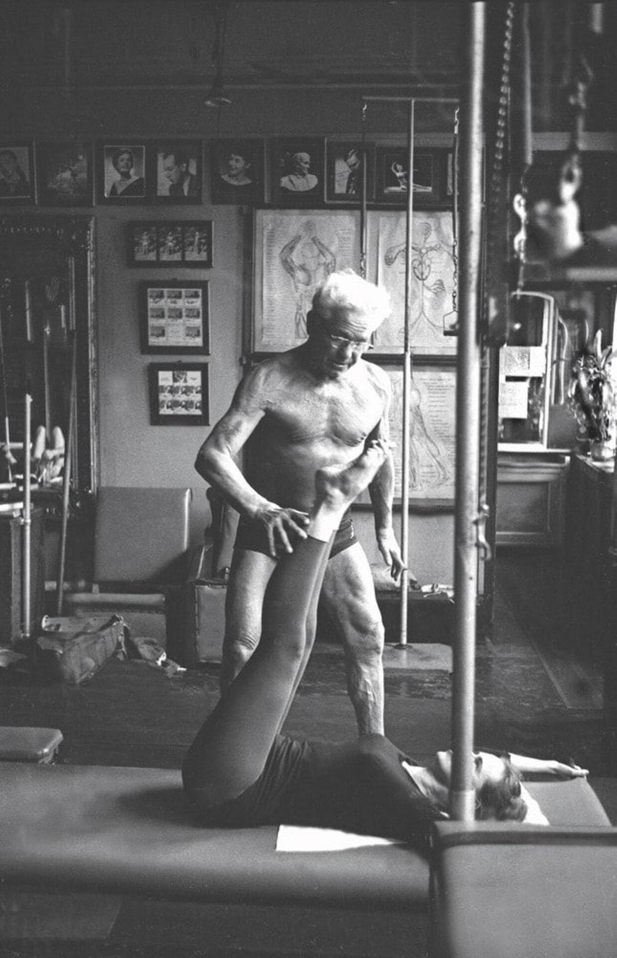 A black-and-white photo of Joseph Pilates at work in his studio.