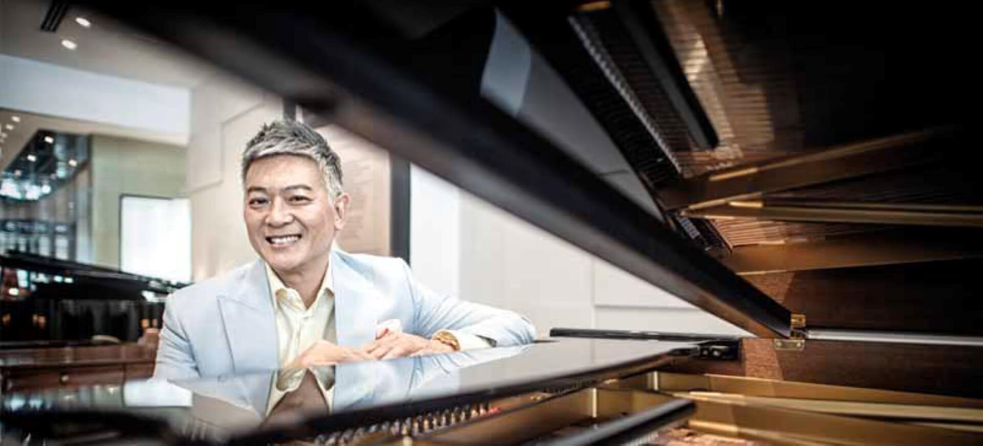 A man with a cheerful expression sits at a piano, embodying a moment of joy and musical expression.