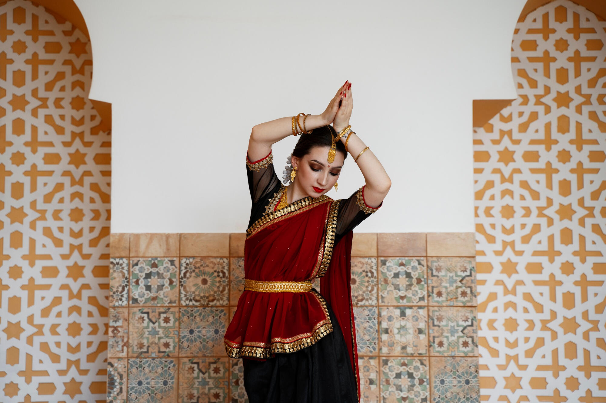 A woman in a traditional Indian outfit performs a graceful dance, showcasing cultural elegance and artistry.