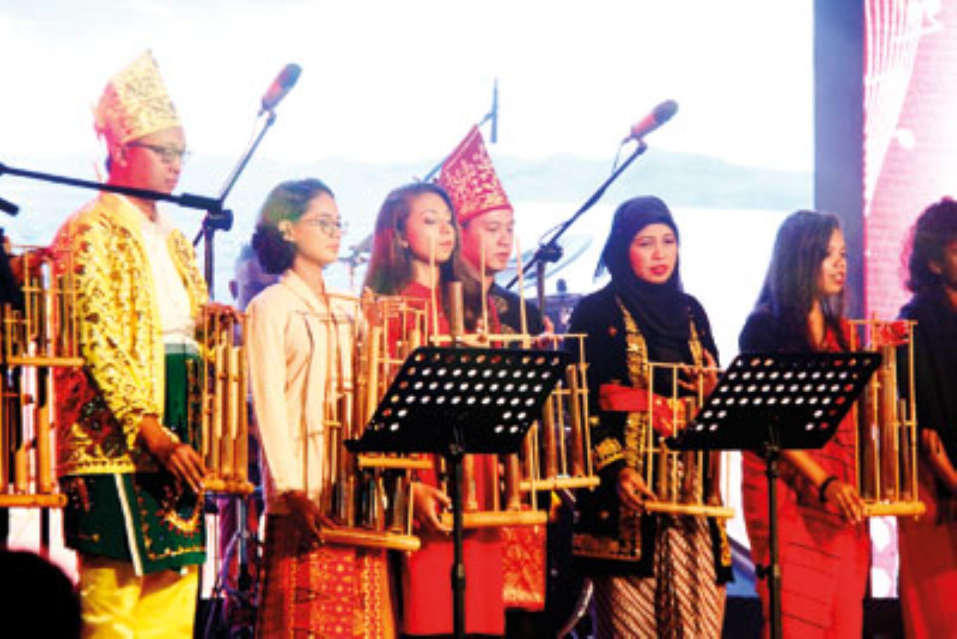 A diverse group of individuals in traditional attire, each holding various musical instruments, showcasing cultural heritage.