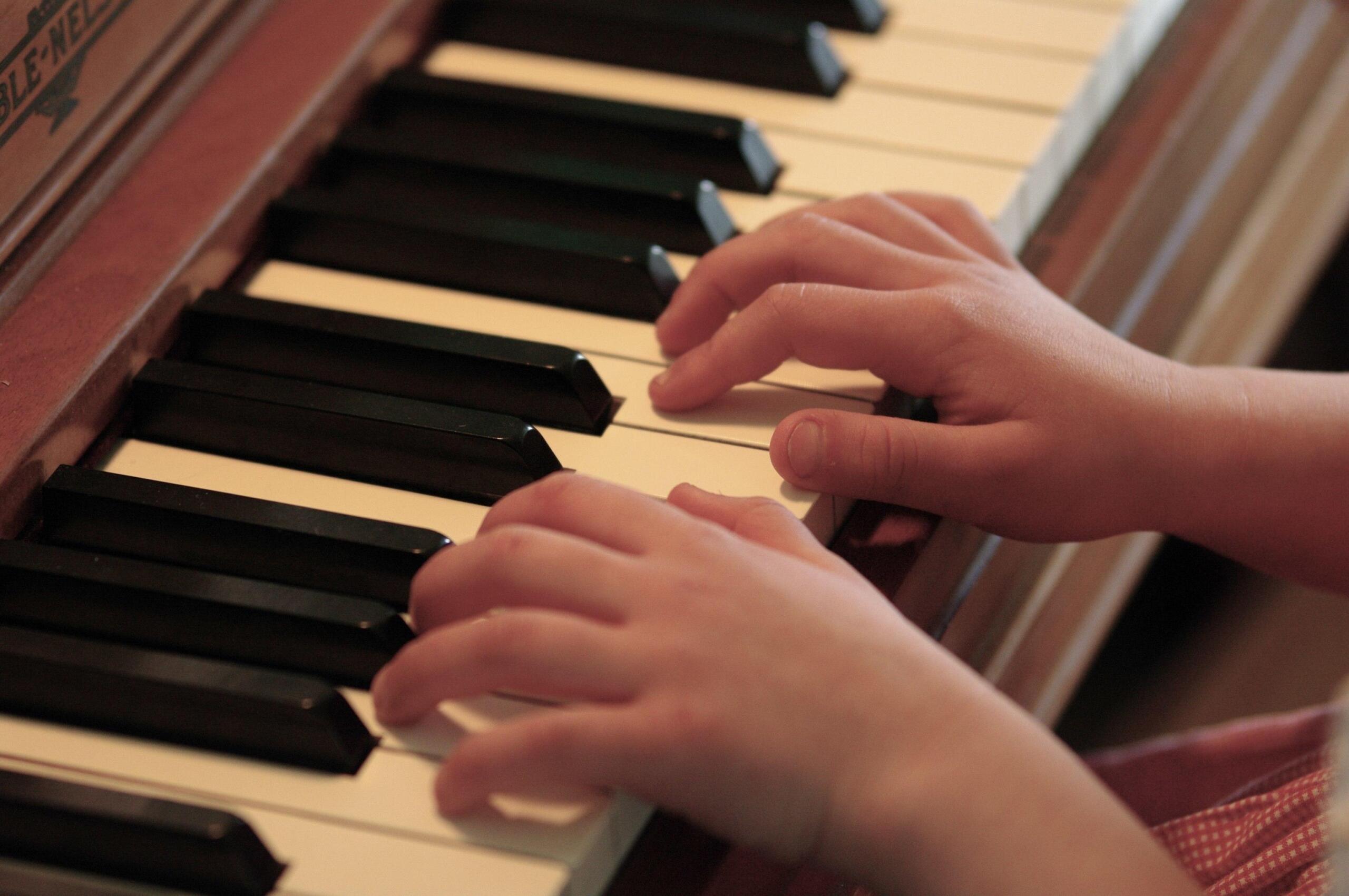 student and teacher learning piano