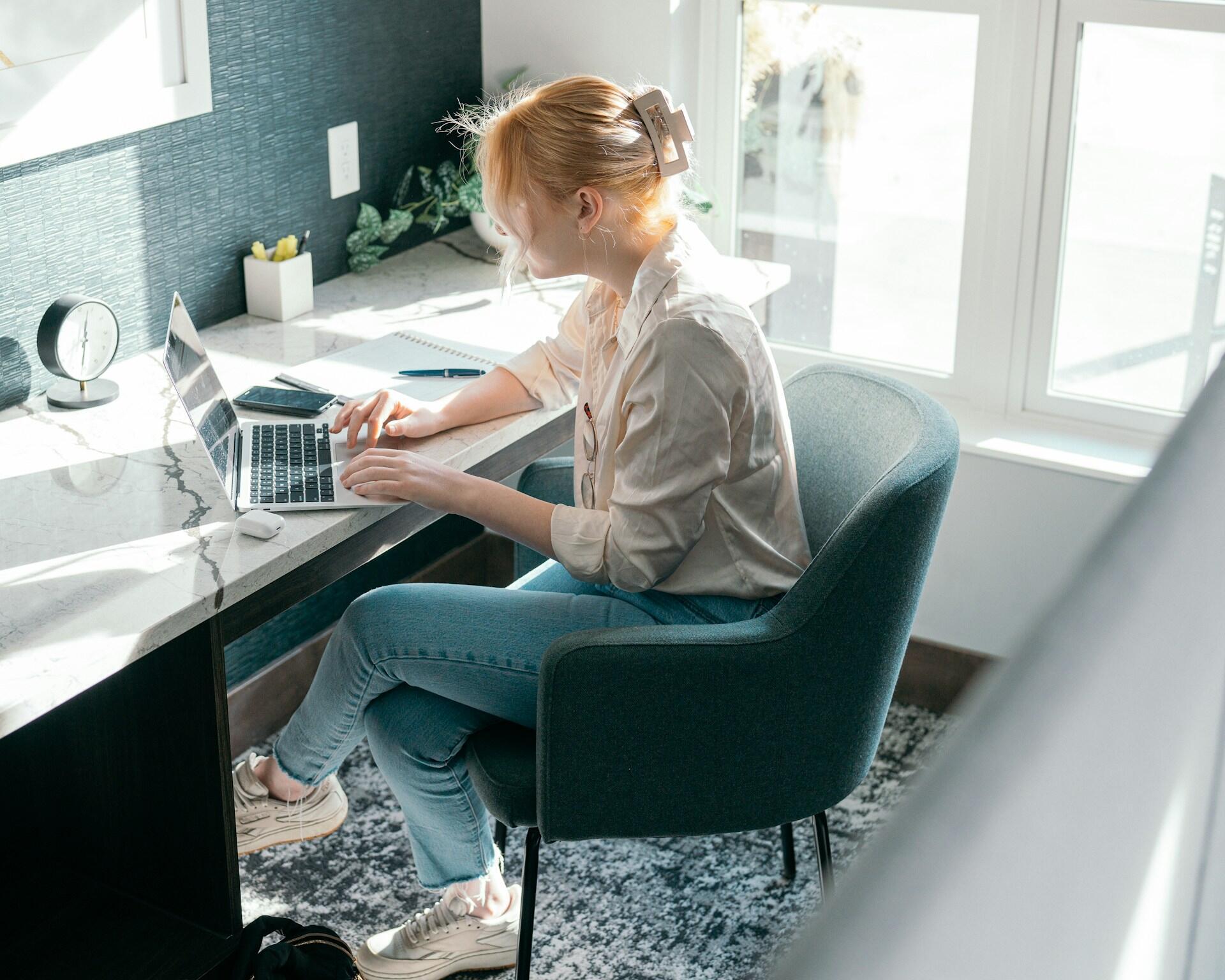 A person at a desk working on a computer.