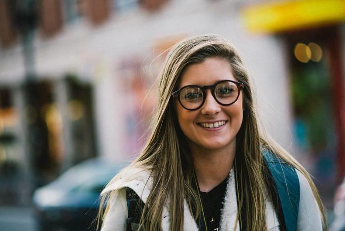 nasmejana punca z očali na ulici znanost študentka