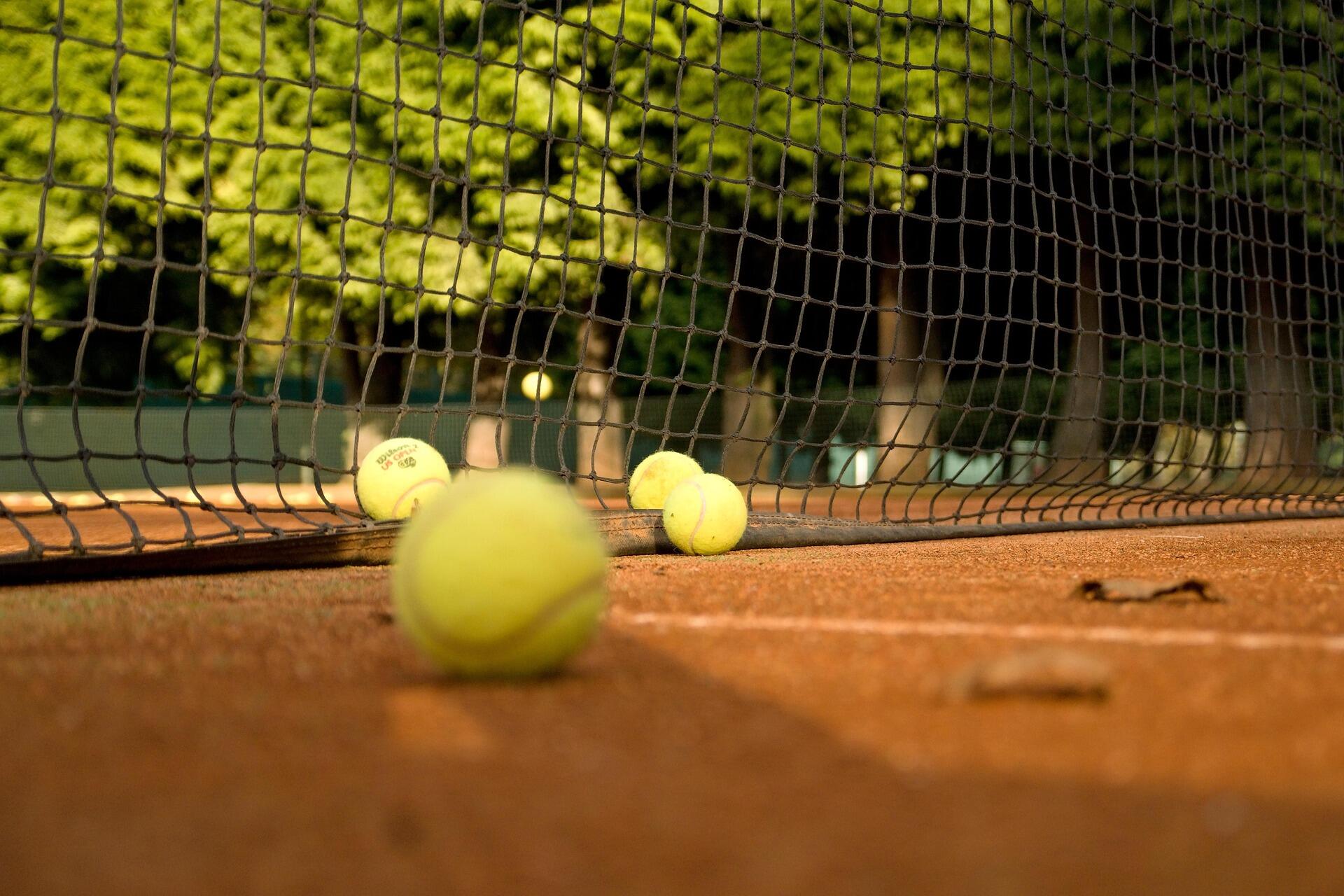kortta dağınık halde bulunan tenis topları görseli