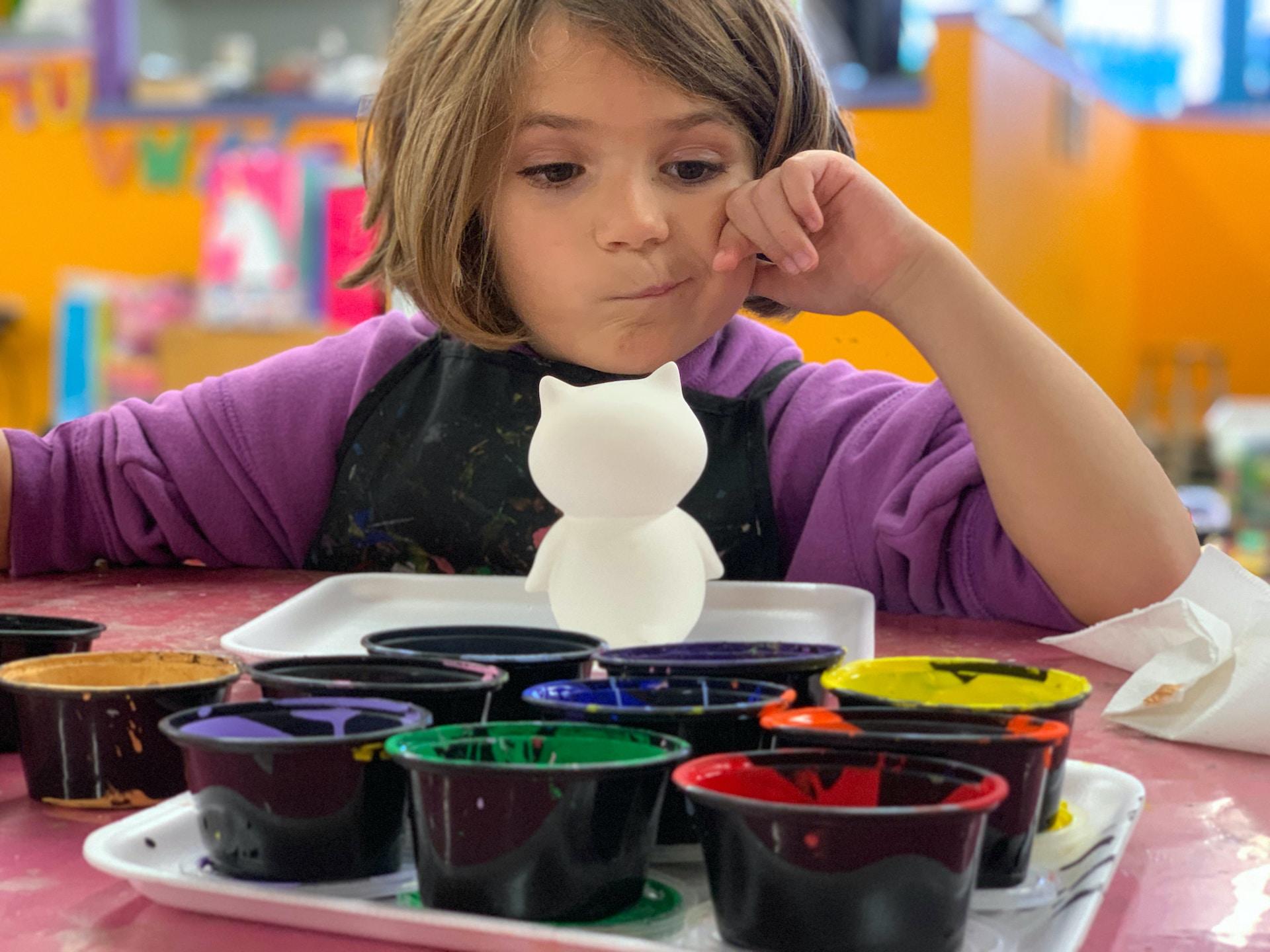 a kid is choosing the paint