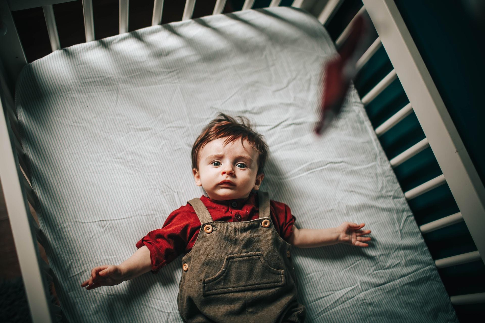 a toddler in the bed