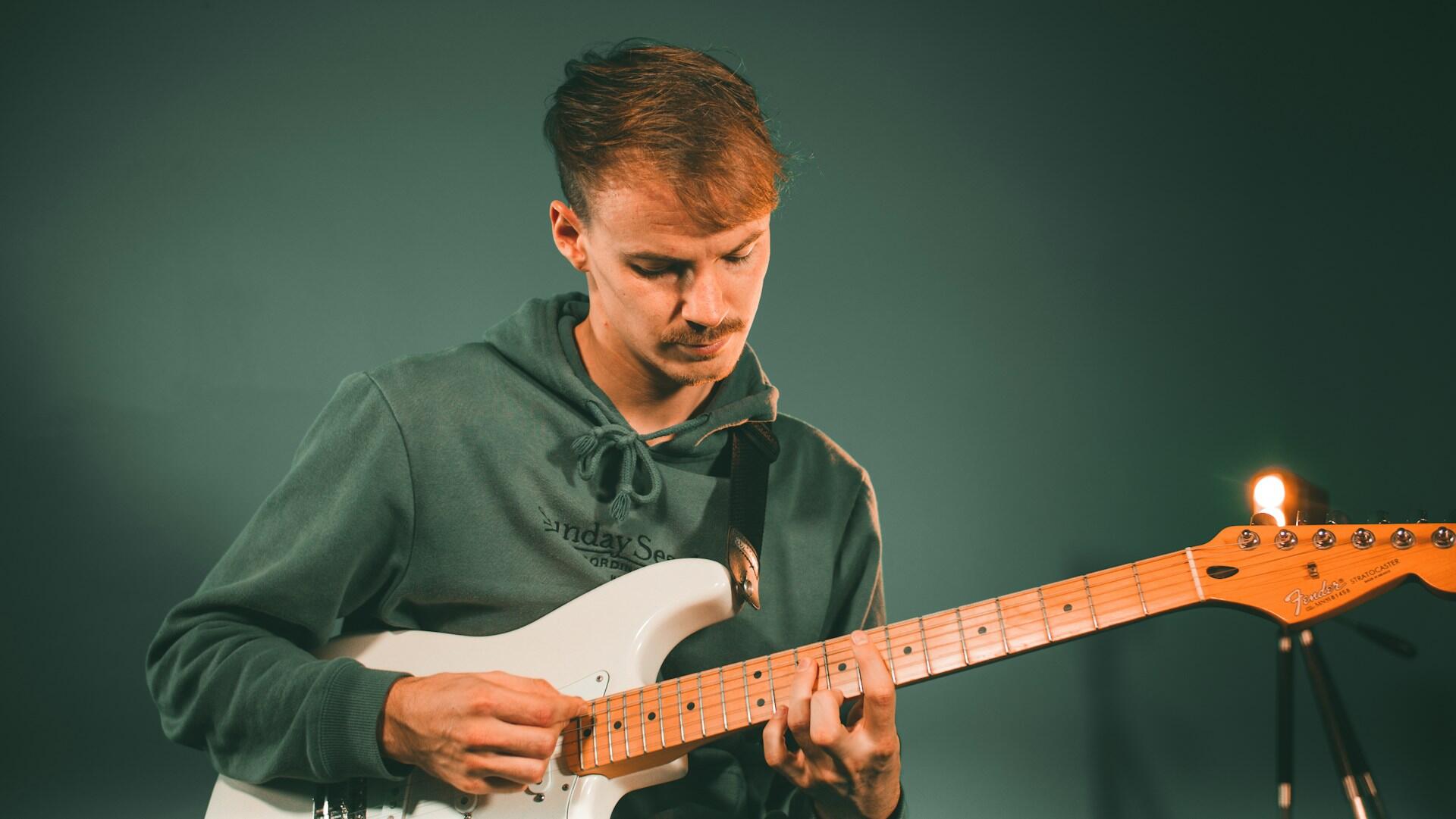 a boy playing electric guitar