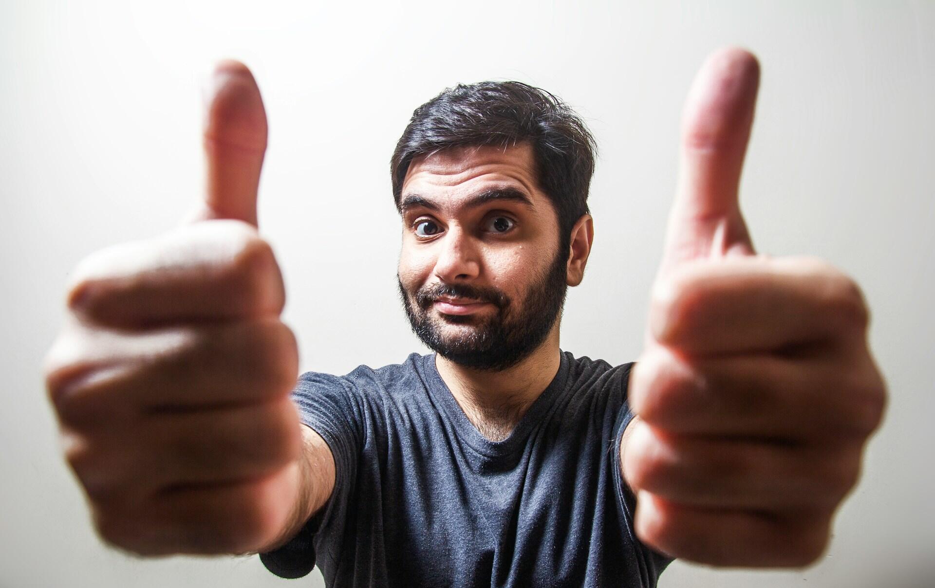 a man showing his two thumbs up