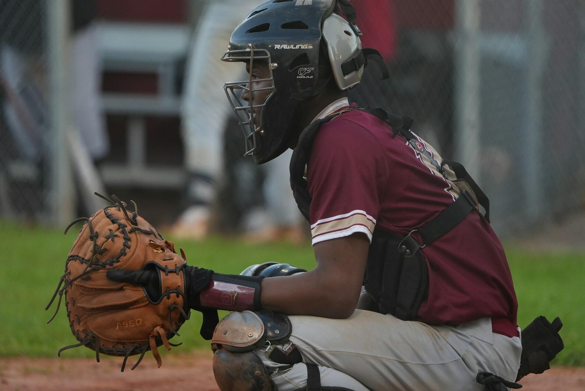 a baseball player in a sitting position