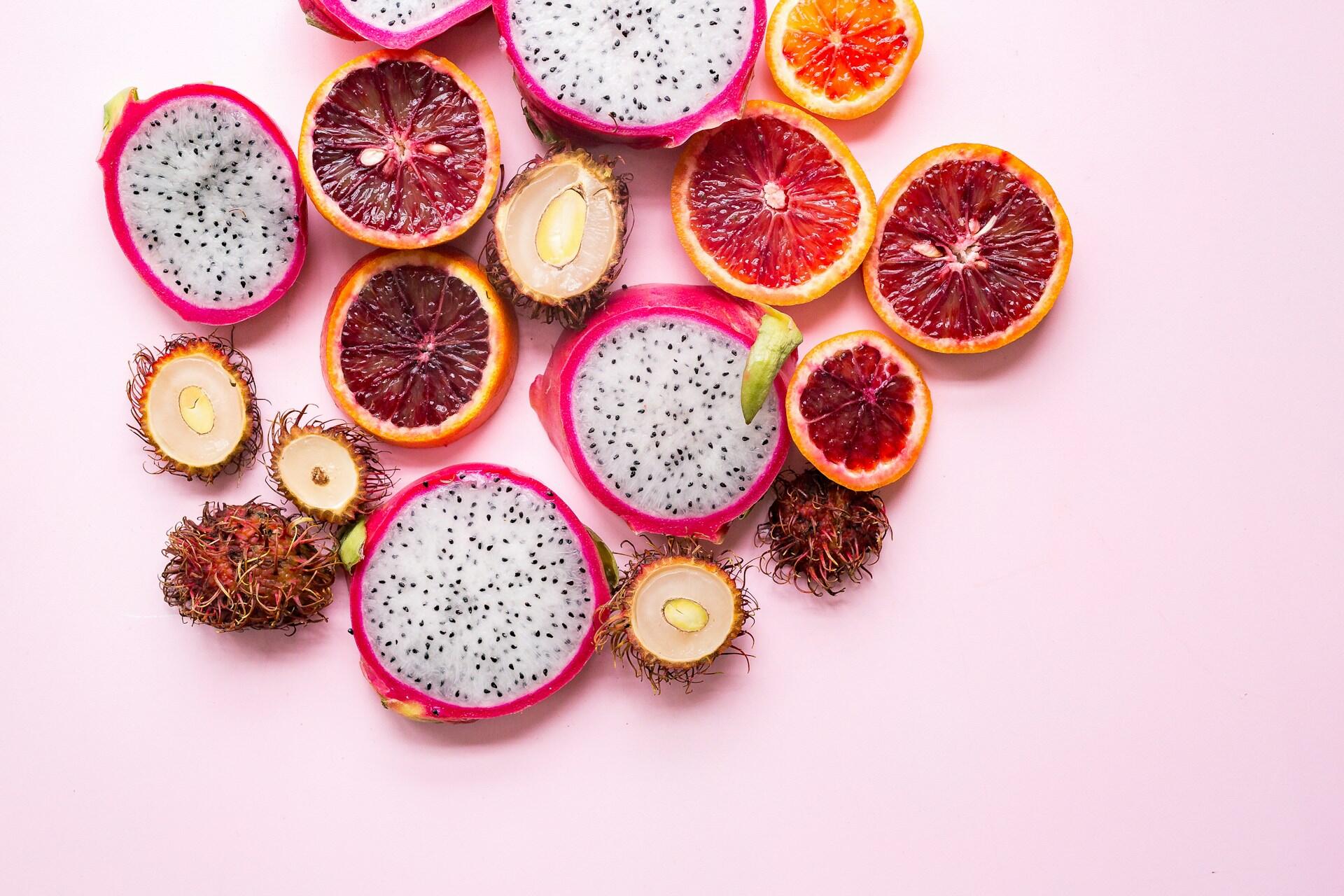 different exotic fruits on the pink background