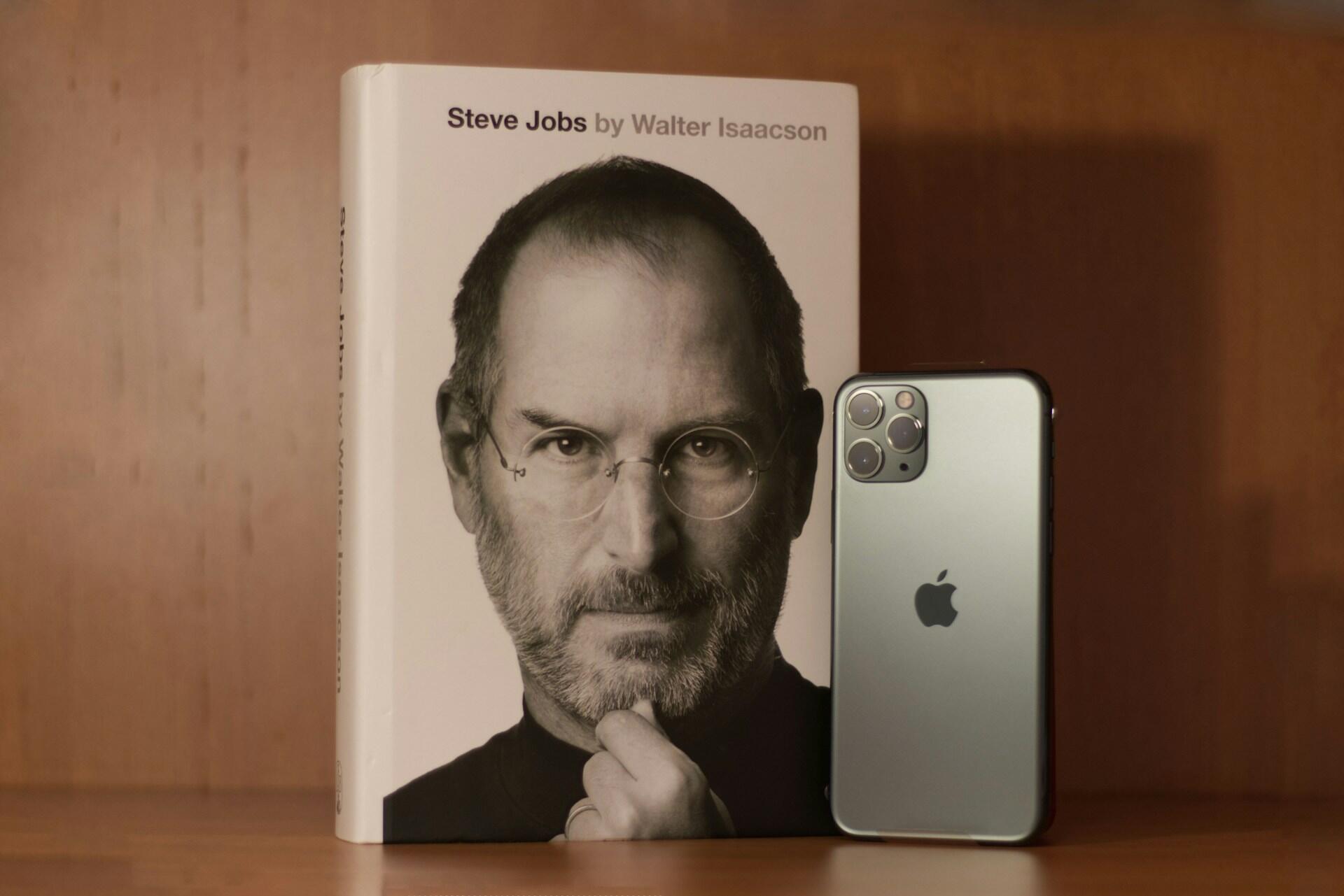 a book and a smartphone next to the wall