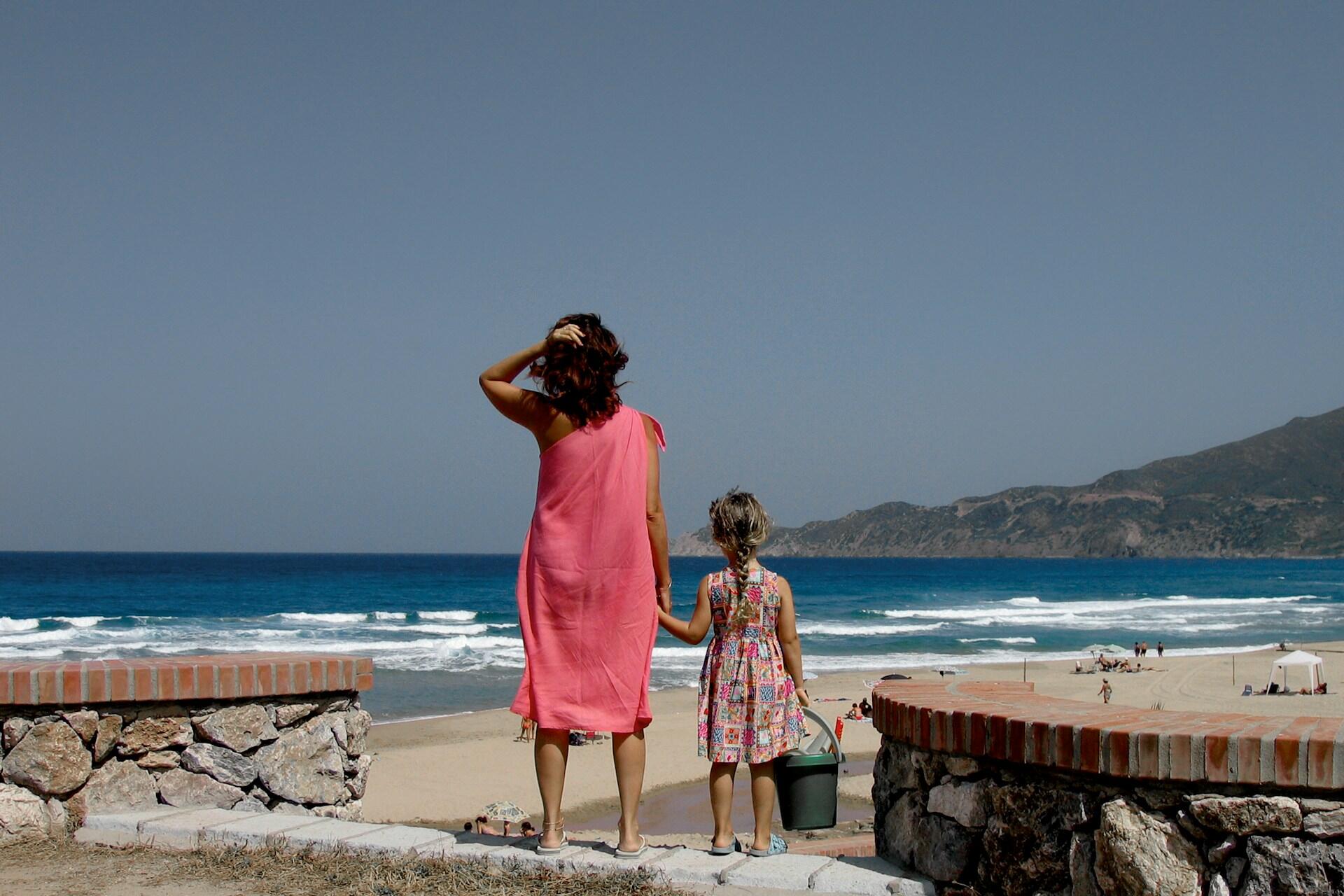 a mom and daughter on the beach