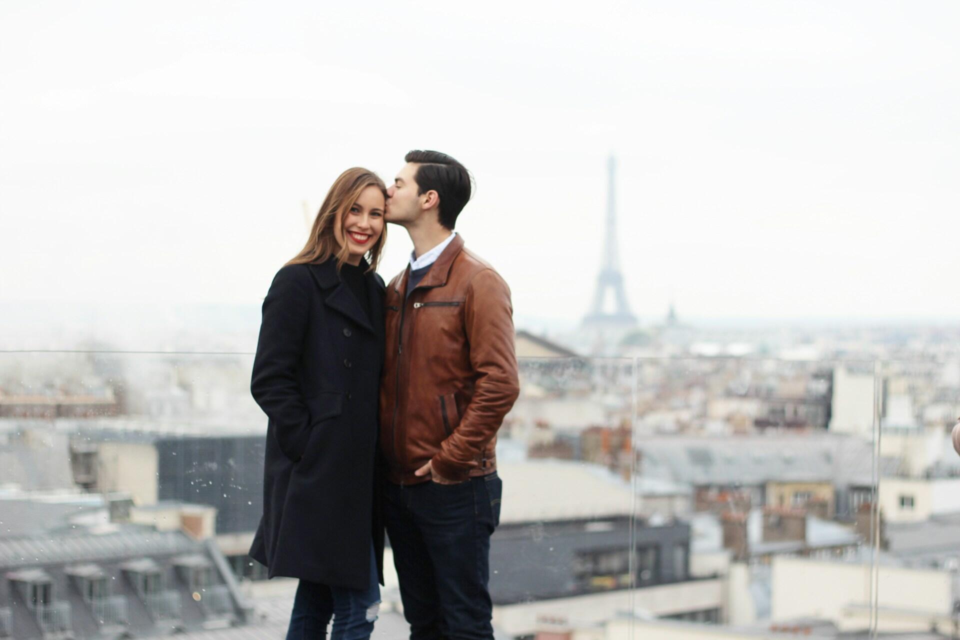 couple next to eiffel tower
