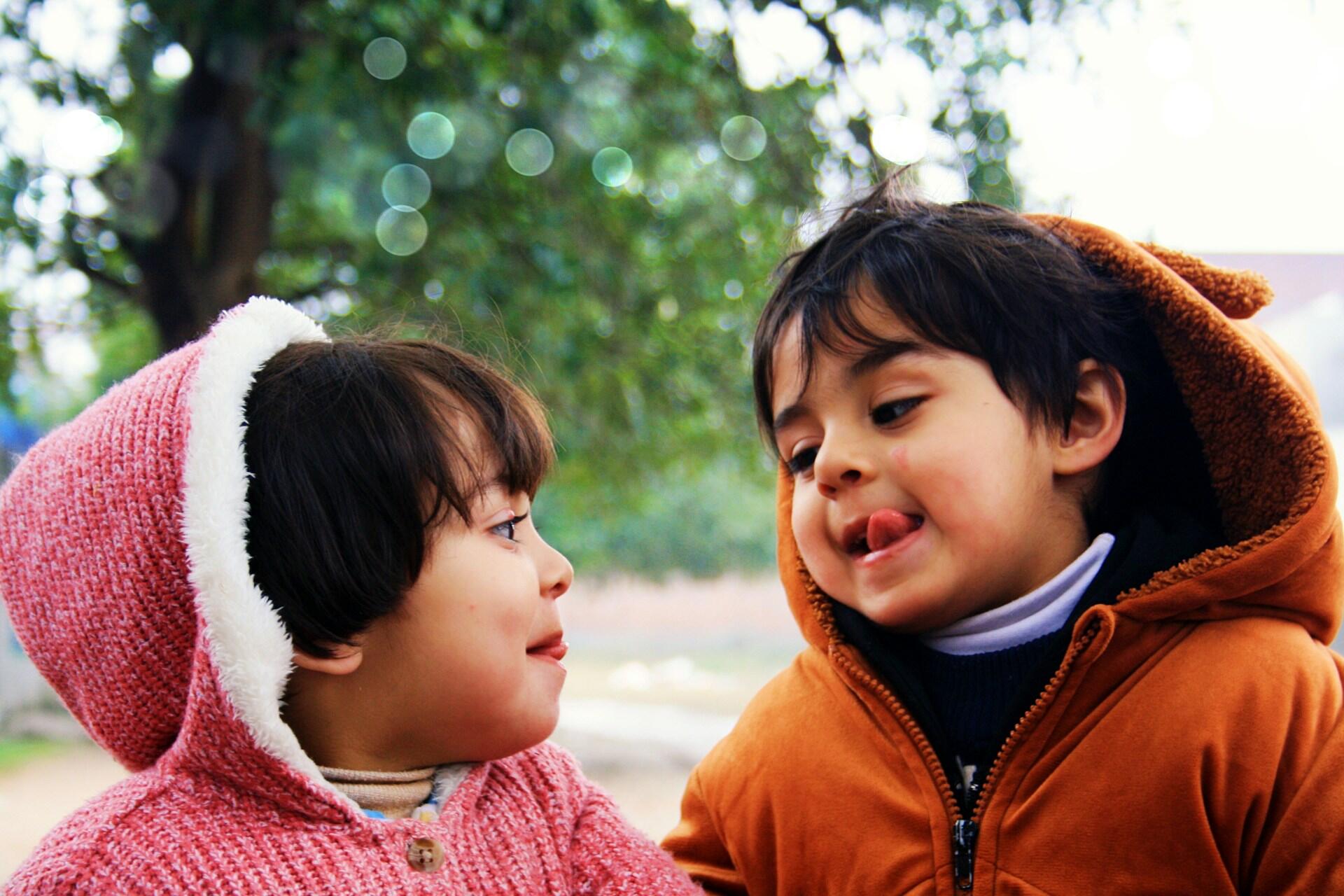 two kids are making funny faces