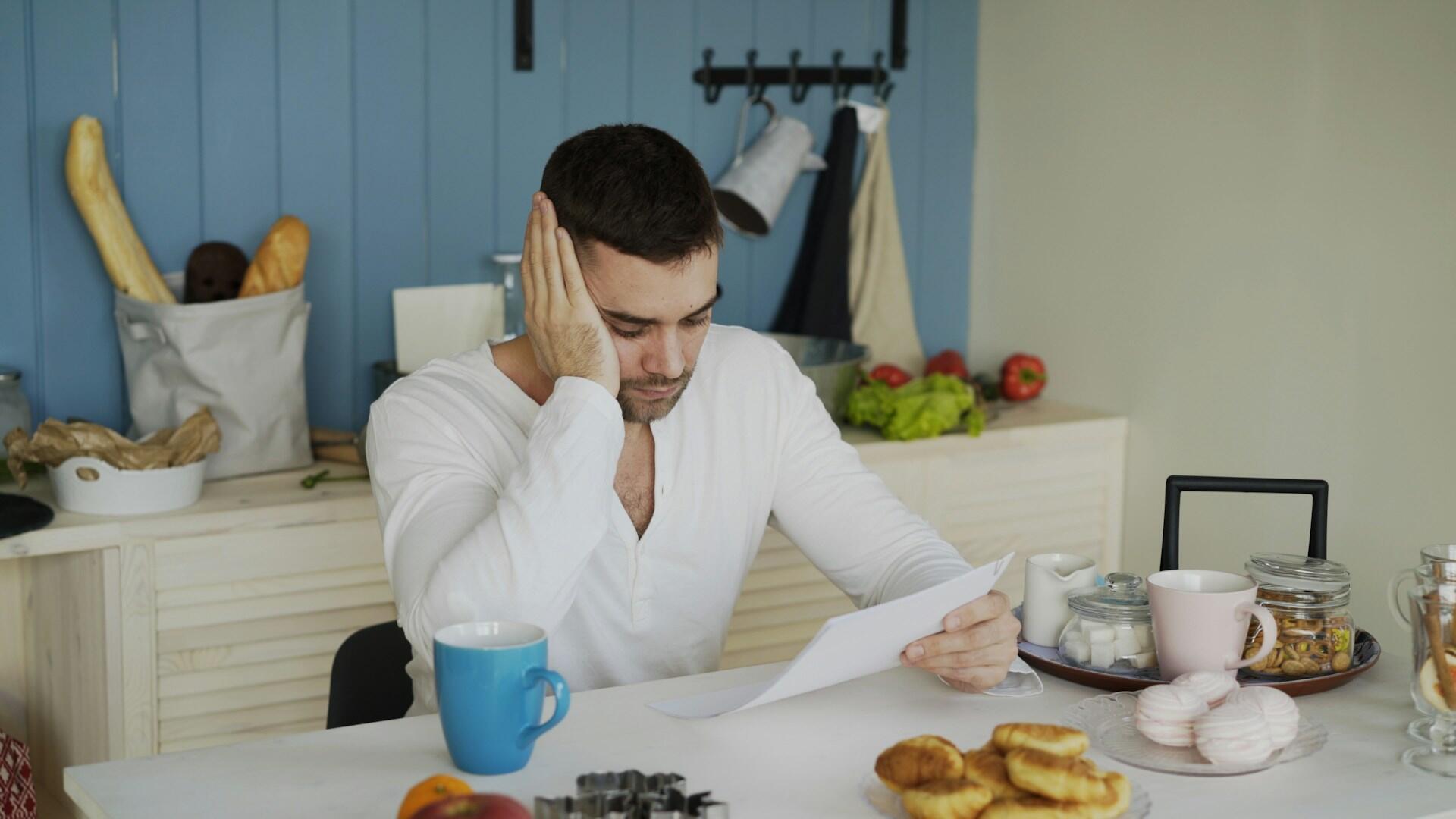 A young man is reading a letter