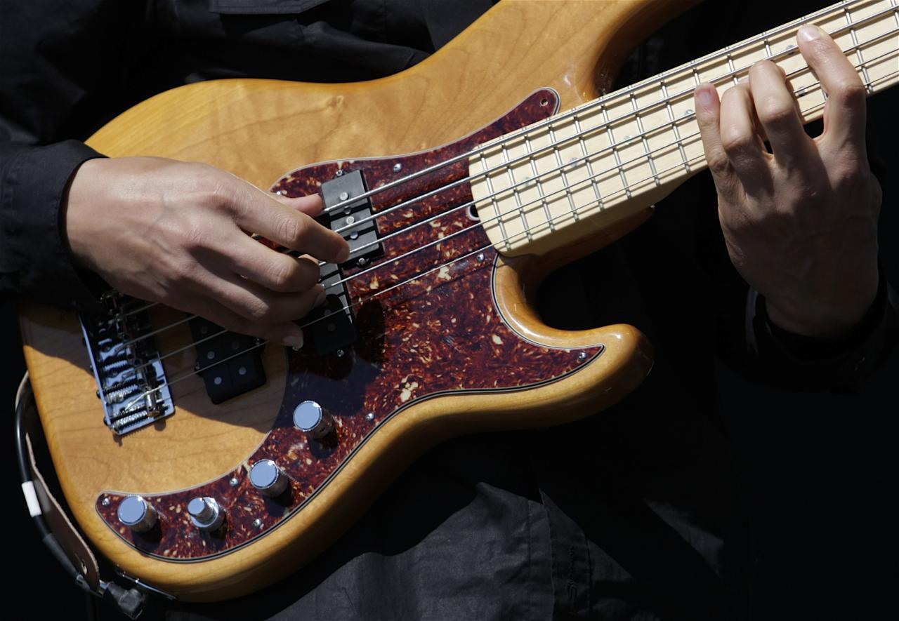 A man plays bass on stage.