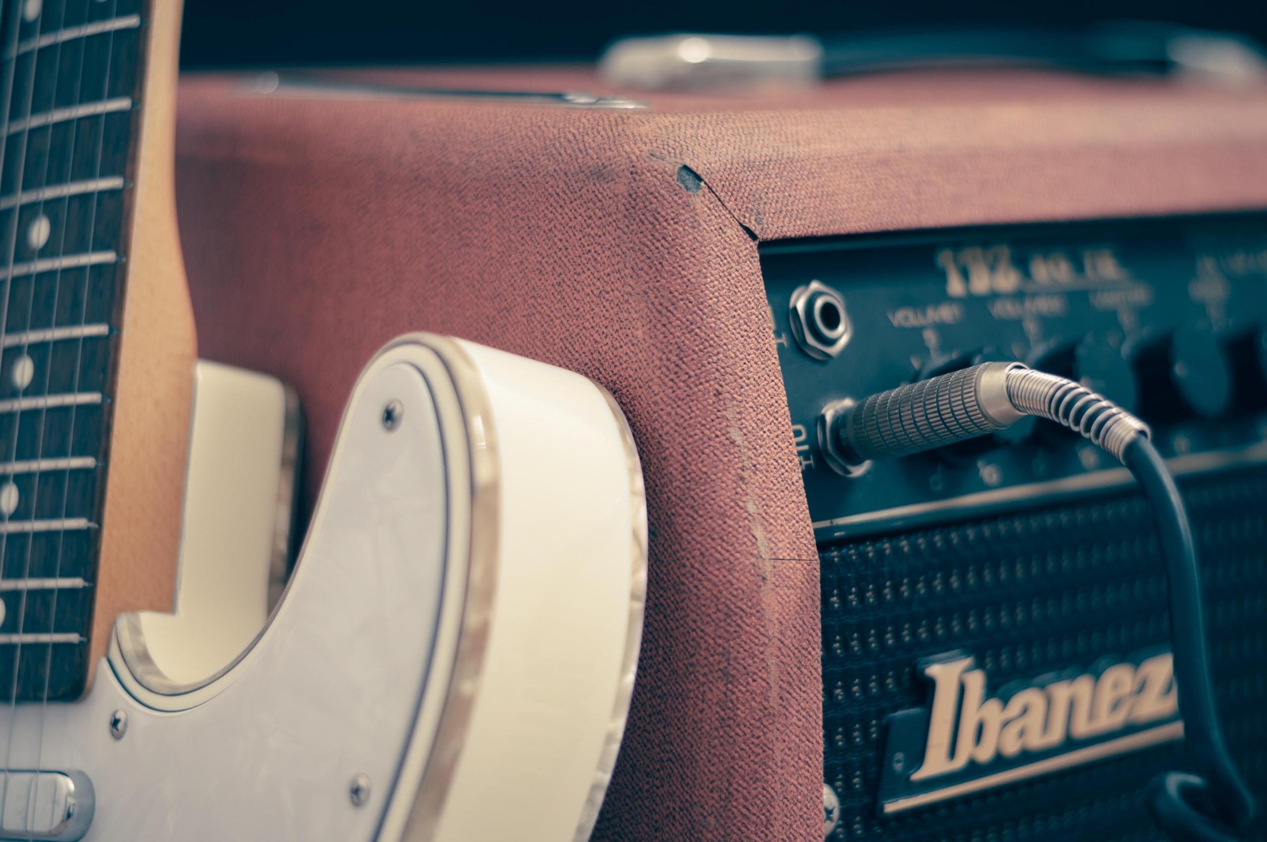 An electric guitar alongside an amp.