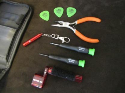 Accessories you might need for a guitar: pliers, picks, and tuner.