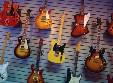 A wall of mounted electric guitars.