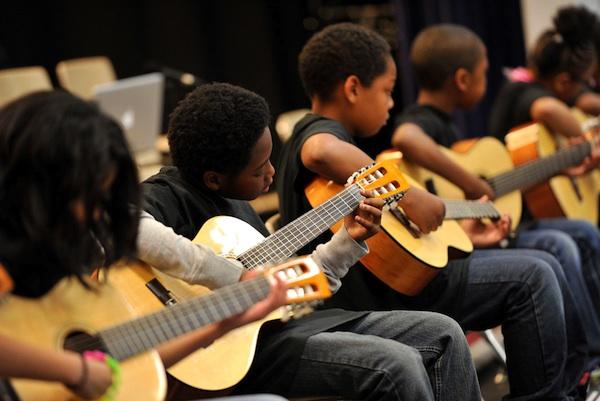 The young guitarists of Music Makes Us hard at work!