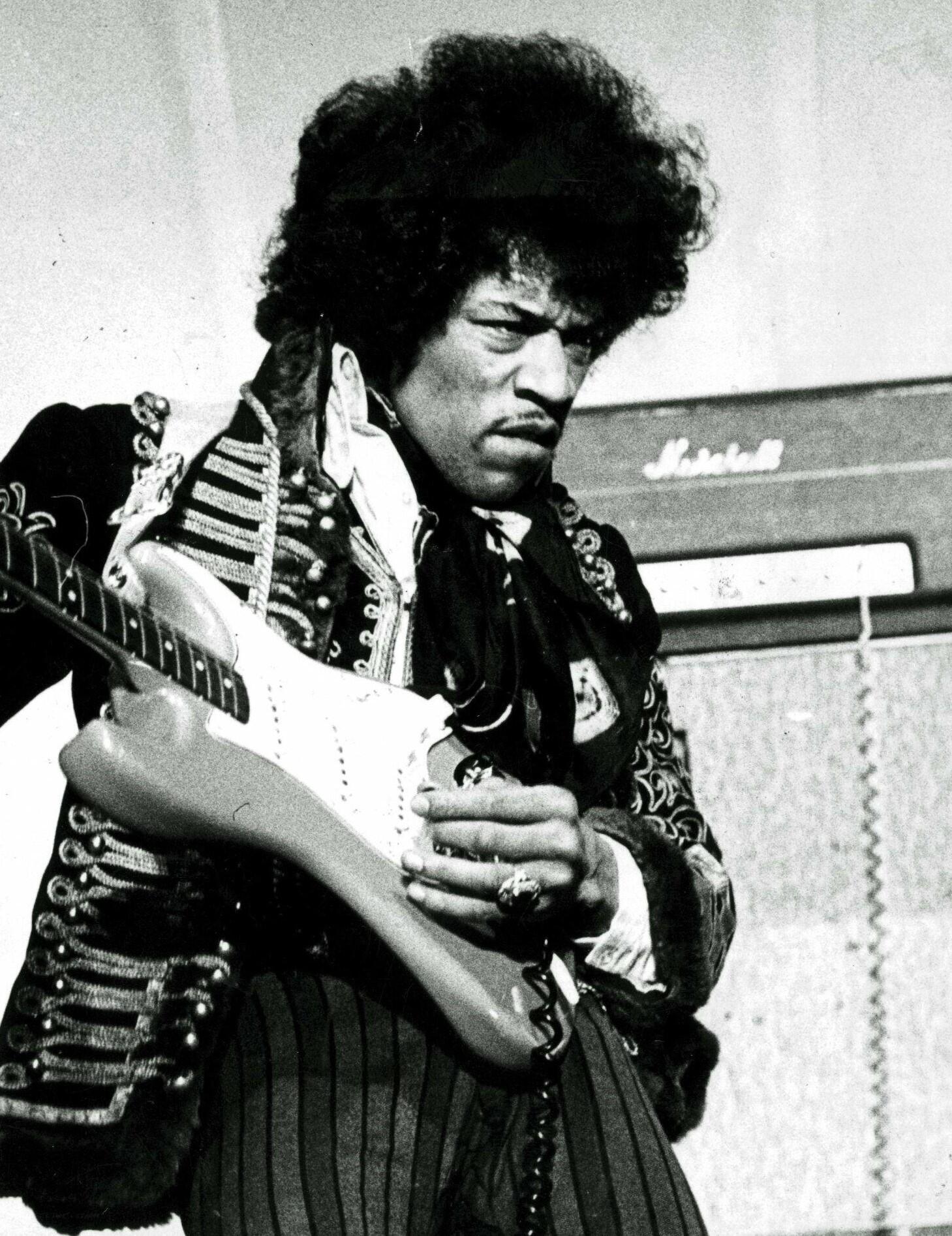 black and white photo of Jimi Hendrix playing guitar