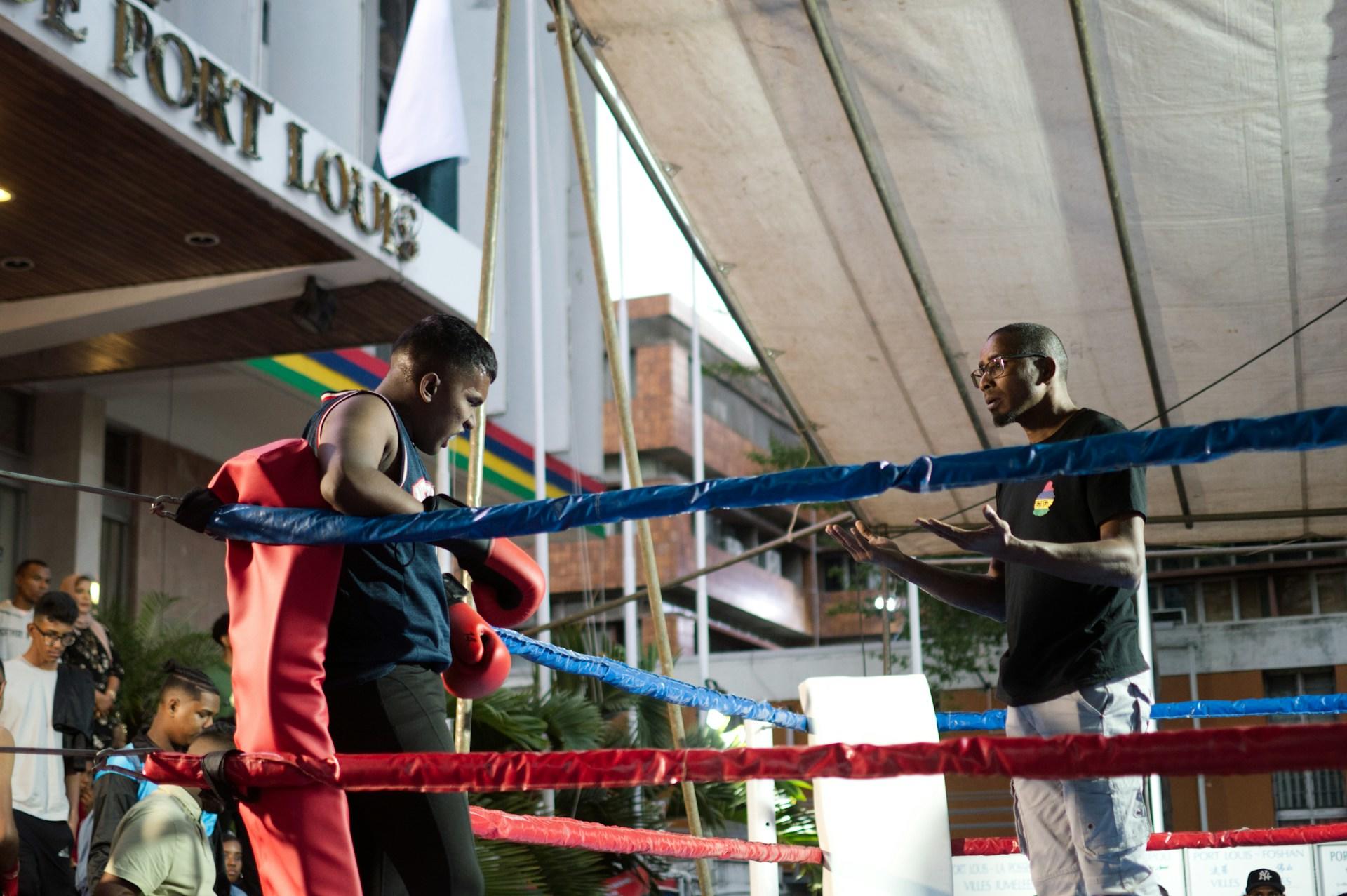 A coach and a boxer in the ring
